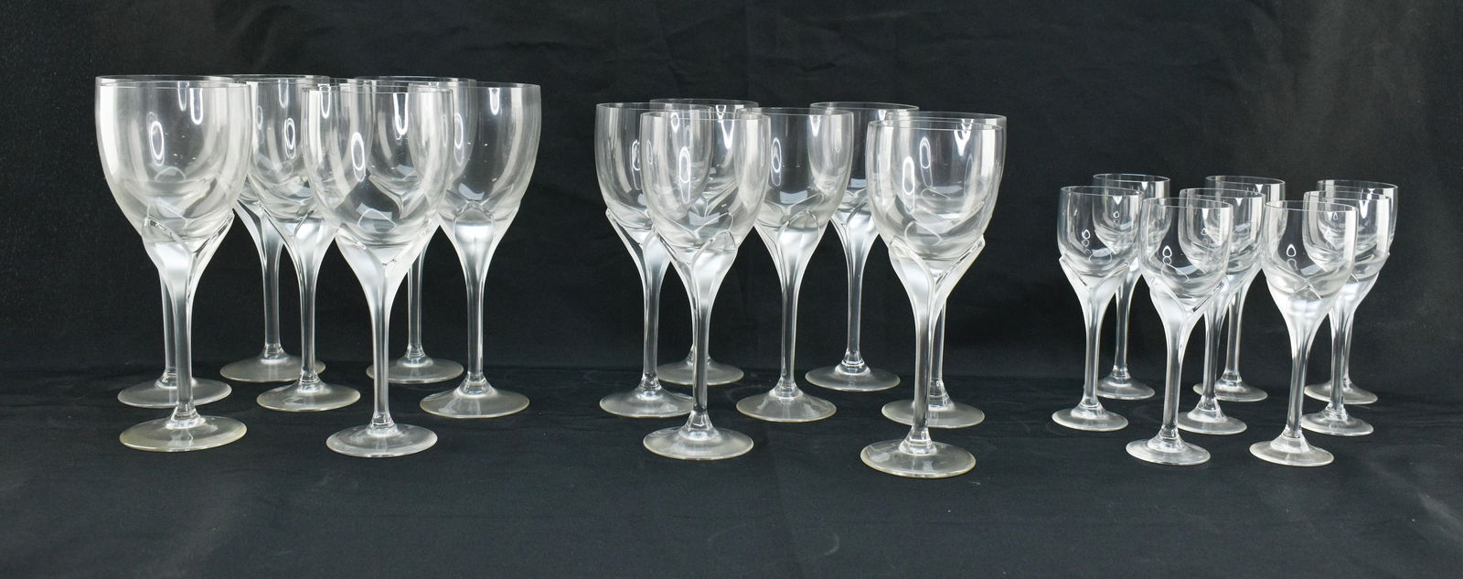 Rosenthal Frosted Stem Iris Pattern Glasses: Rosenthal frosted stemware in pattern "Iris." Set includes seven water goblets, seven wine glasses, and eight cordial glasses. Each glass is mark Rosenthal on the base and features a clear glass bowl