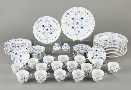 Royal Copenhagen Blue Fluted Dish Set: Royal Copenhagen, Denmark. Blue Fluted dinnerware set, including 16 teacups, 18 bread plates, six appetizer plates, nine dinner plates, and salt and pepper shakers. Each decorated with vibrant blue fl