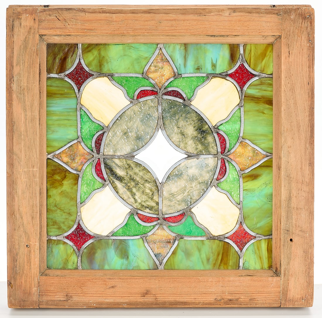 Square Arts & Crafts Stained Glass Windows: Square Arts & Crafts or Art Nouveau slag stained glass transomwindow with geometric motifs. Opaque patterned glass with green, purple, and blue slag glass. Wooden frame.Height: 18 in x width: 18 in x