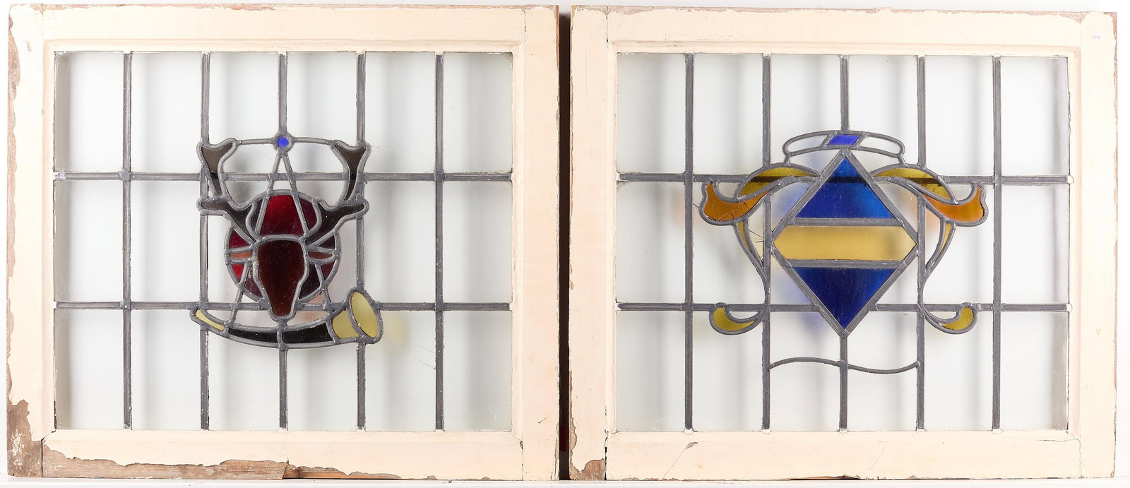 Set 2 Arts & Crafts Stained Glass Windows: Set of two Arts & Crafts or Art Nouveau slag stained glass windows. One with stag and horn; the second with geometric motif. Wooden frame.(Each) Height: 23 in x width: 27 1/2 in x depth: 2 in.