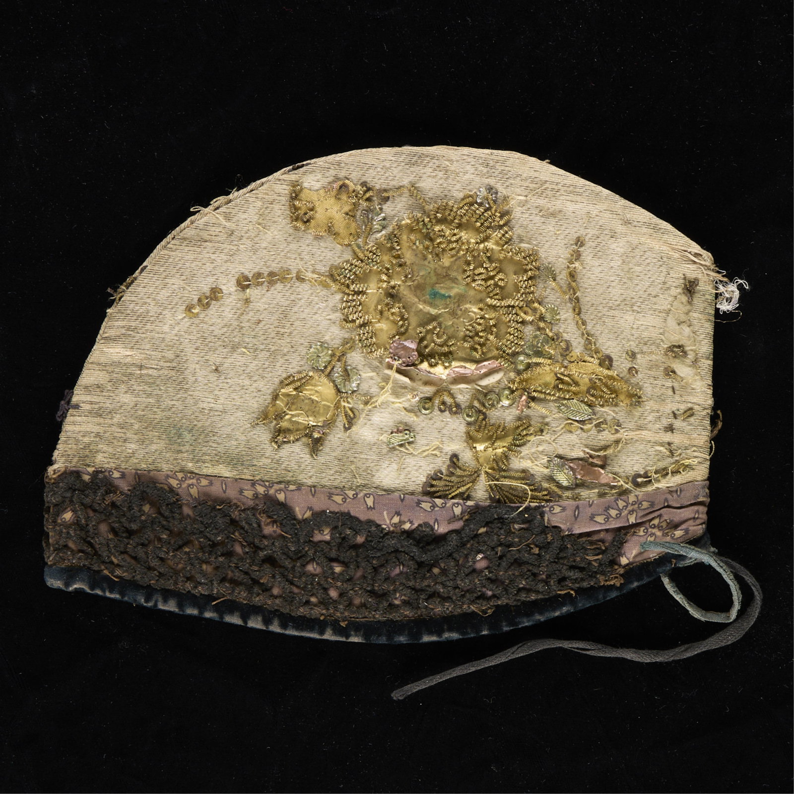 Gold Embroidered Festive Bonnet: Likely upper Austria or Southern Germany (Swabia, Bavaria), ca. 1800-1850. Close-fitting woman's cap richly embroidered with metallic threads and sequins in floral and scroll motifs. Structured in for