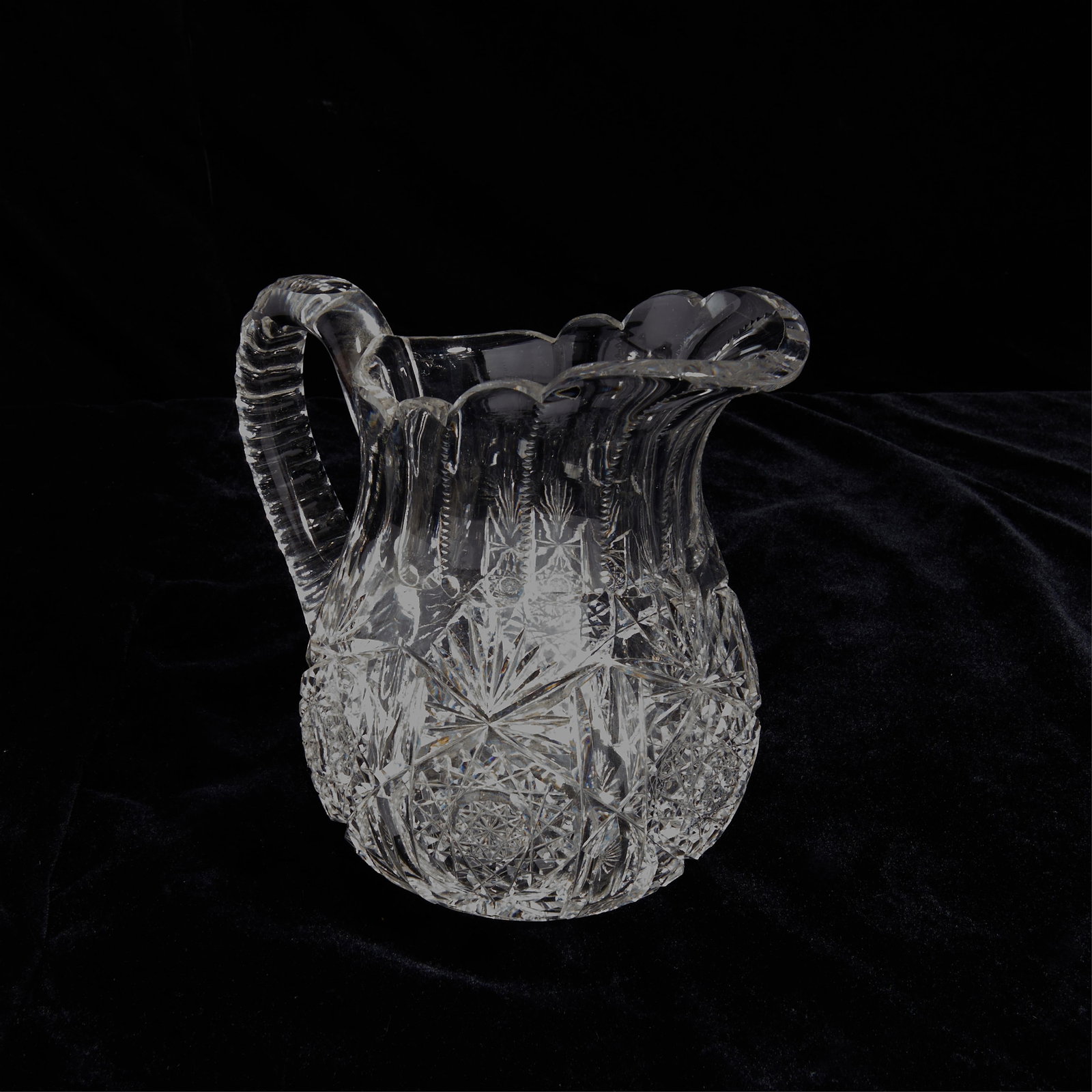 Cut Glass Crystal Round Pitcher or Jug: Cut glass or crystal handled pitcher or jug.Height: 8 in x width: 8 in x diameter: 6 in.