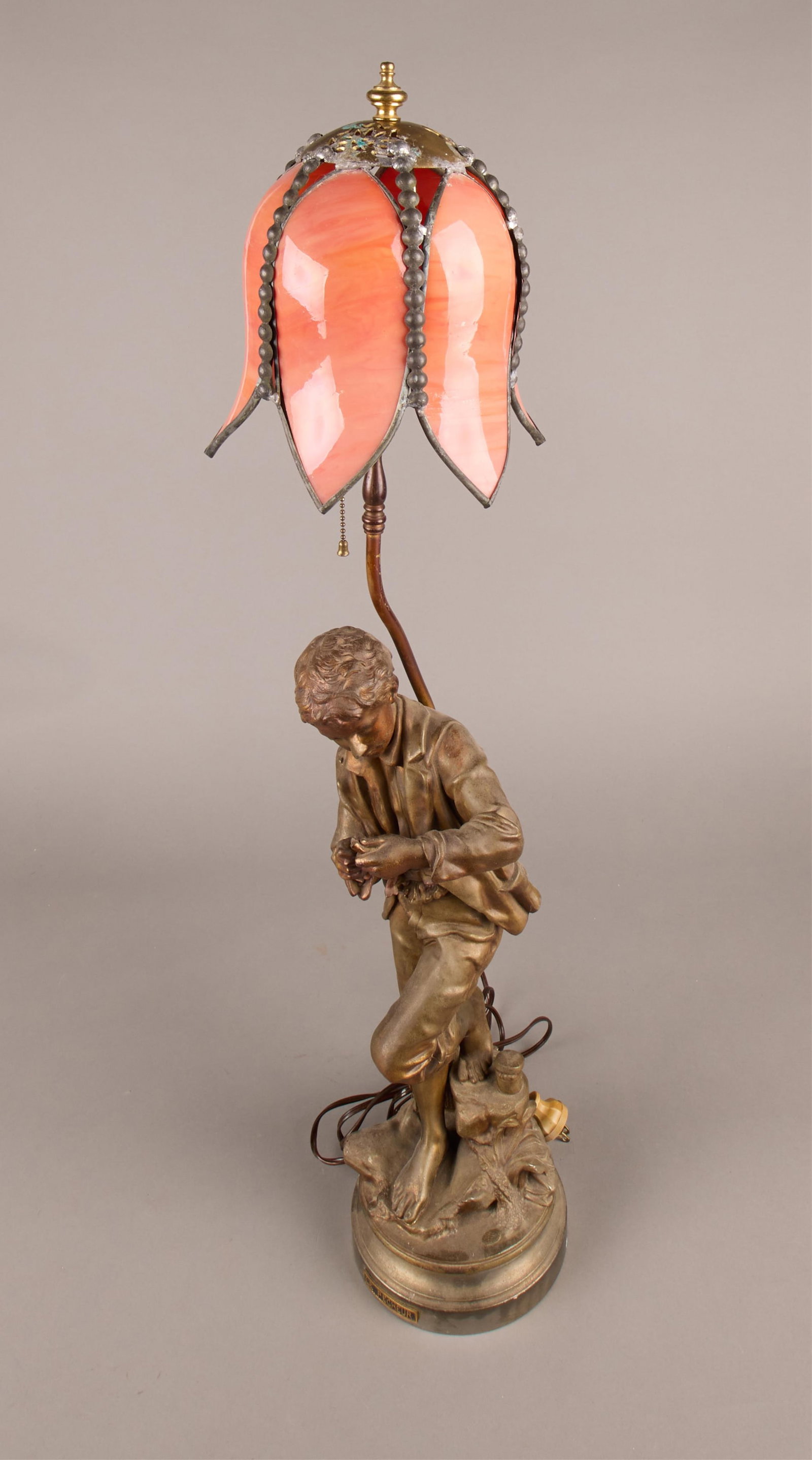 "Le Pecheur" Bronze Lamp w/ Orange Glass Shade: Antique "Le Pecheur" bronze lamp with intricate orange glass shade in petal form.Height: 35 in x diameter: 9 in.
