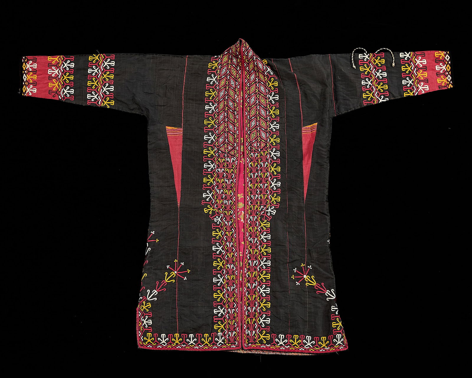 19th/20th c. Uzbek Silk Embroidered Chrypy Robe: Uzbek, Tekke, or Turkoman embroidered women's jacket or chrypy (robe), late 19th to early 20th. The garment with colorful silk embroidery depicting hooked ram's horns symbols, geometric forms, and lin