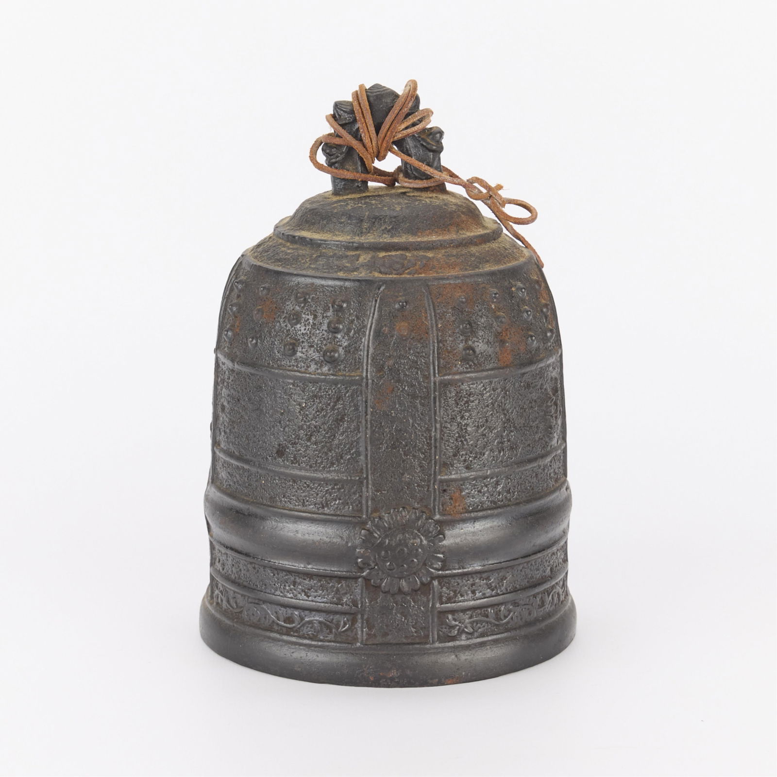 Bronze Bell w/ Dragon Handle: Antique bronze bell. Featuring sunflower detailing in relief and small handle along the top in the form of a dragon.Height: 7 in x diameter: 5 1/2 in.