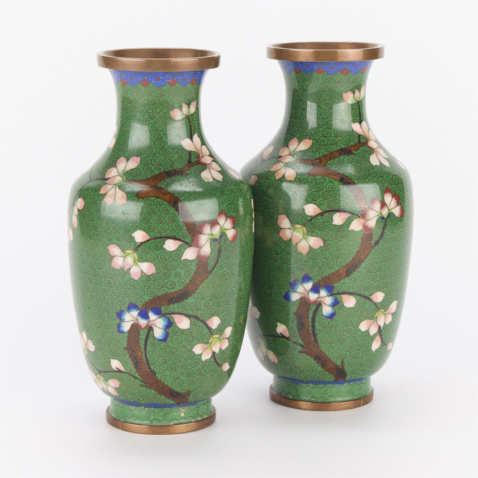 Pair Green Chinese Cloisonne Vases: Pair of Chinese cloisonne vases. Green ground with pink blossoming branches. Marked "China" along the underside.(Each) Height: 9 1/4 in x diameter: 4 1/4 in.