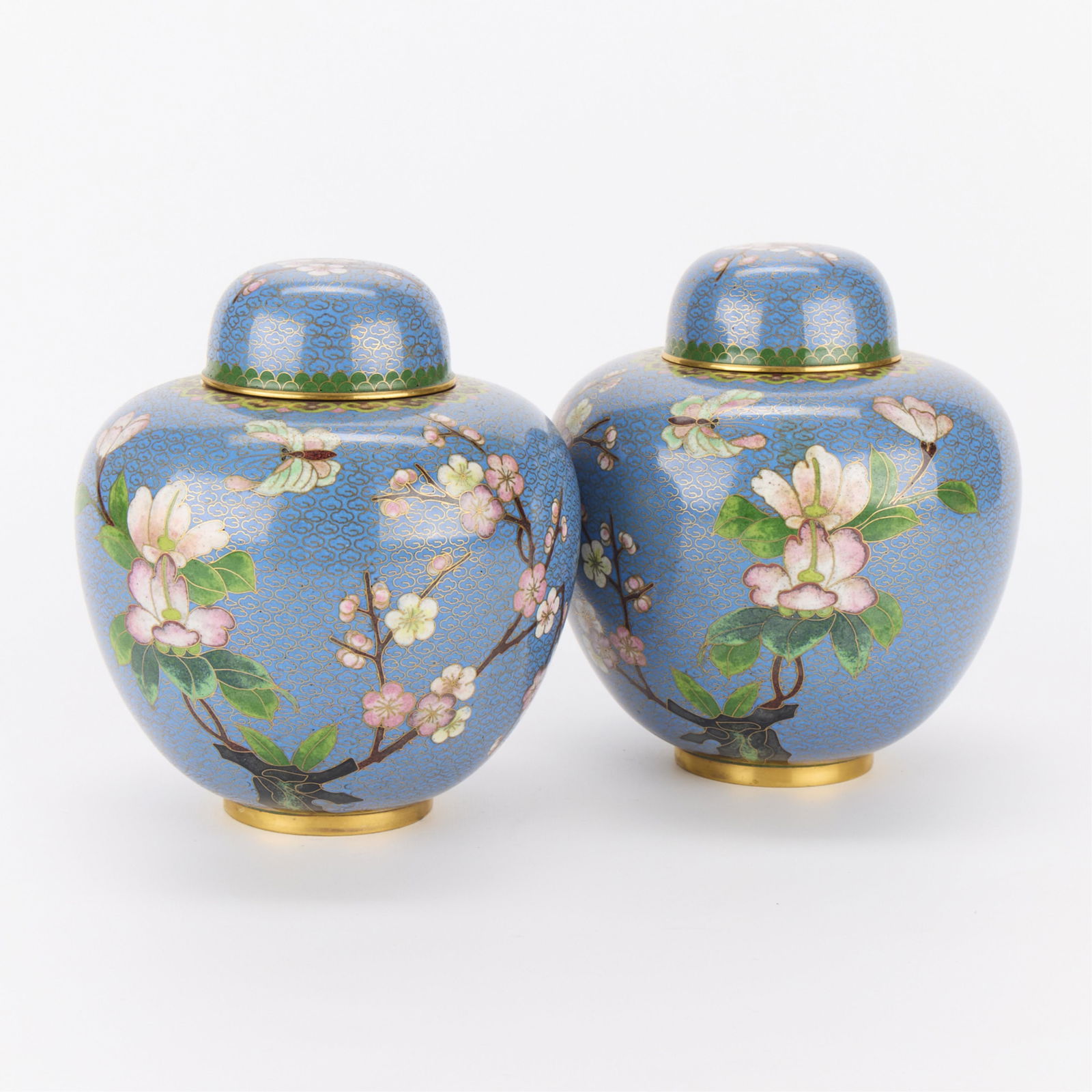 Pair Round Chinese Cloisonne Vases: Pair of rotund Chinese cloisonne lidded vases. Blue ground with pink blooming flowers.(Each) Height: 7 1/2 in x diameter: 7 in.