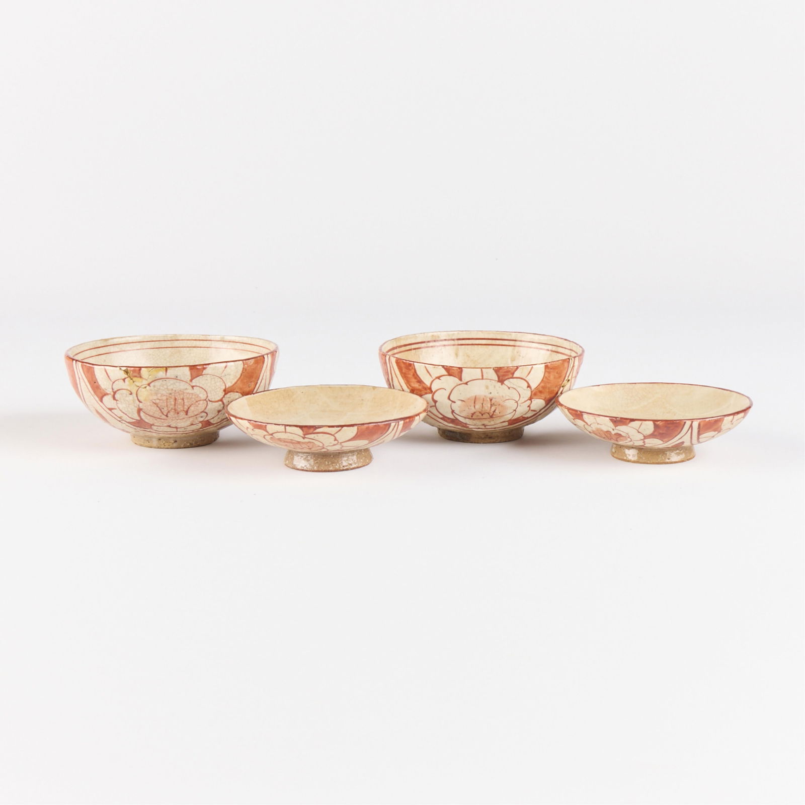 4 Pcs Japanese Ceramic Iron Red Bowls & Saucers: Including two pottery bowls and two footed saucers. Depicting floral motifs executed in iron red glaze against white ground. Each bowl marked along the underside.(Saucers) Diameter: 4 1/2 in. (Bowls)