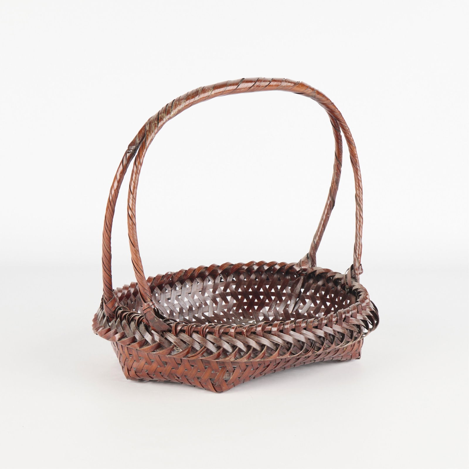 Japanese Bamboo Woven Ikebana Floral Basket: Japanese woven bamboo cane ikebana floral arrangement basket of an oval form with high arched handle.Height: 11 3/4 in x width: 11 1/2 in x depth: 9 1/2 in.