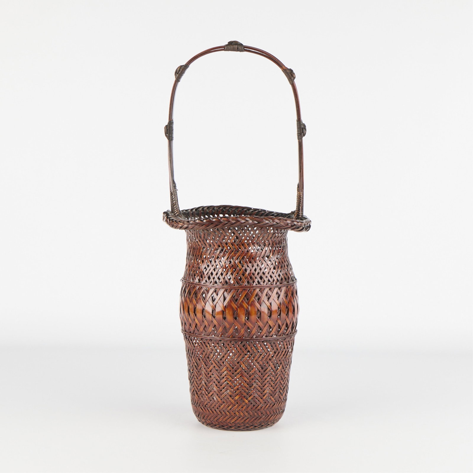 Tall Japanese Woven Ikebana Floral Basket: Tall Japanese woven cane ikebana floral arrangement basket with high arched handle. Height: 18 3/4 in x diameter: 7 1/2 in.