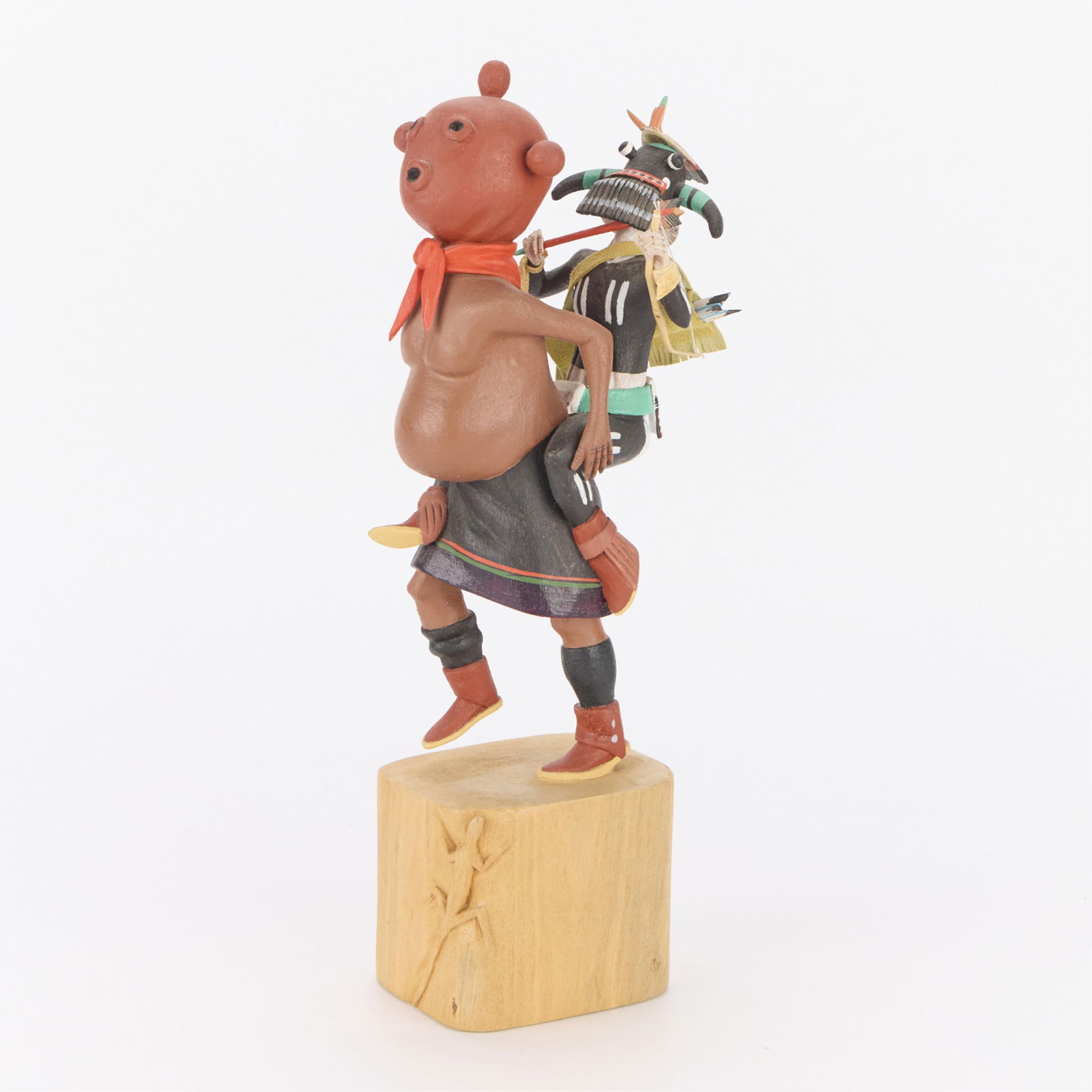 Silas Roy "Mudhead Carrying Tuhavi" Kachina: Hopi katsina polychrome carved wood katsina doll depicting Mudhead carrying the paralyzed Tuhavi. Signed in pen along the underside. Label from Allard Auctions.Height: 10 1/2 in x width: 2 1/2 in x de