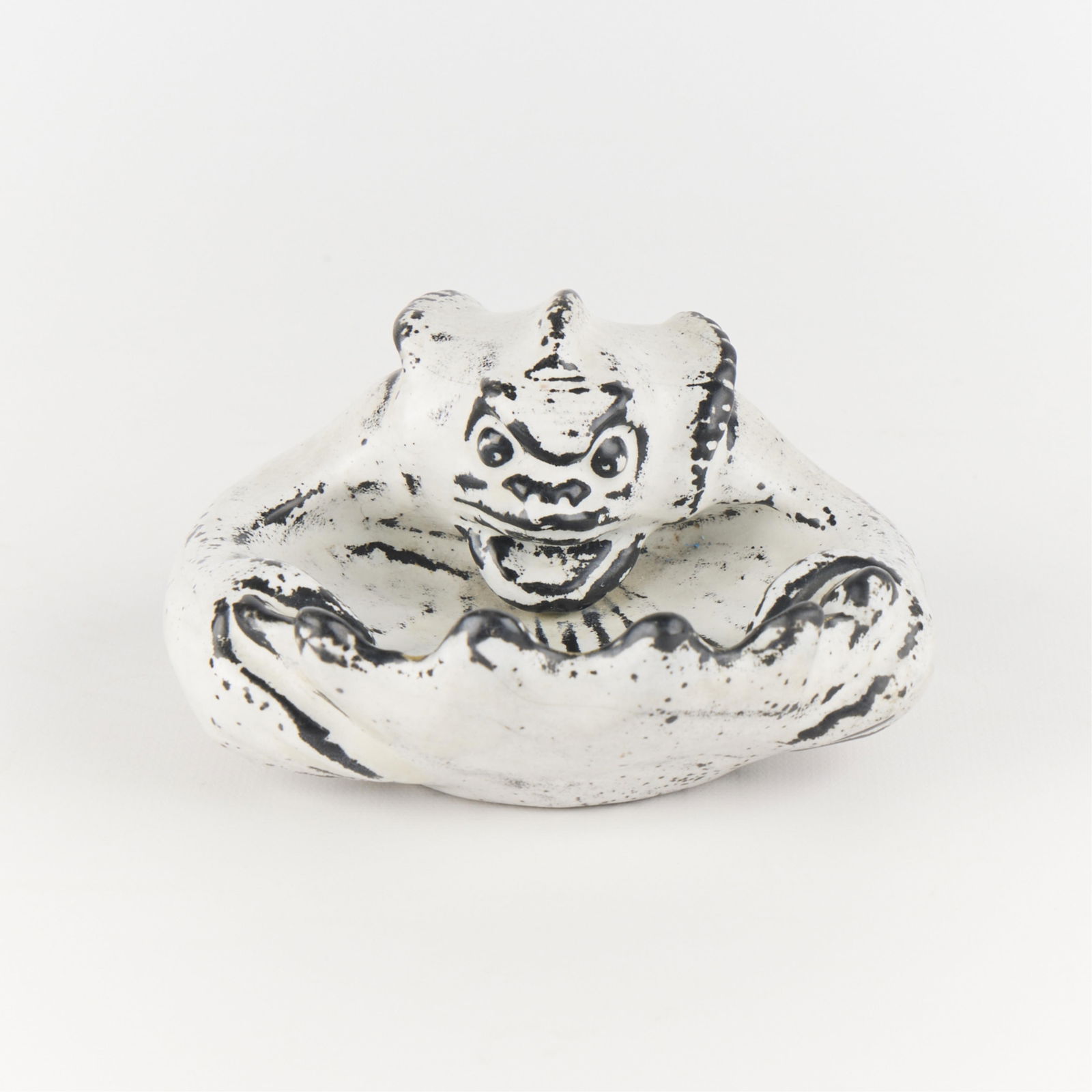 Herman A. Kahler Ceramic Sculptural Sea Creature: Danish ceramic sculpture depicting a zoomorphic sea creature clutching a large shell, 19th-20th century. Incised signature and "Danmark" along the underside.Height: 2 1/2 in x width: 5 in x depth: 5 1