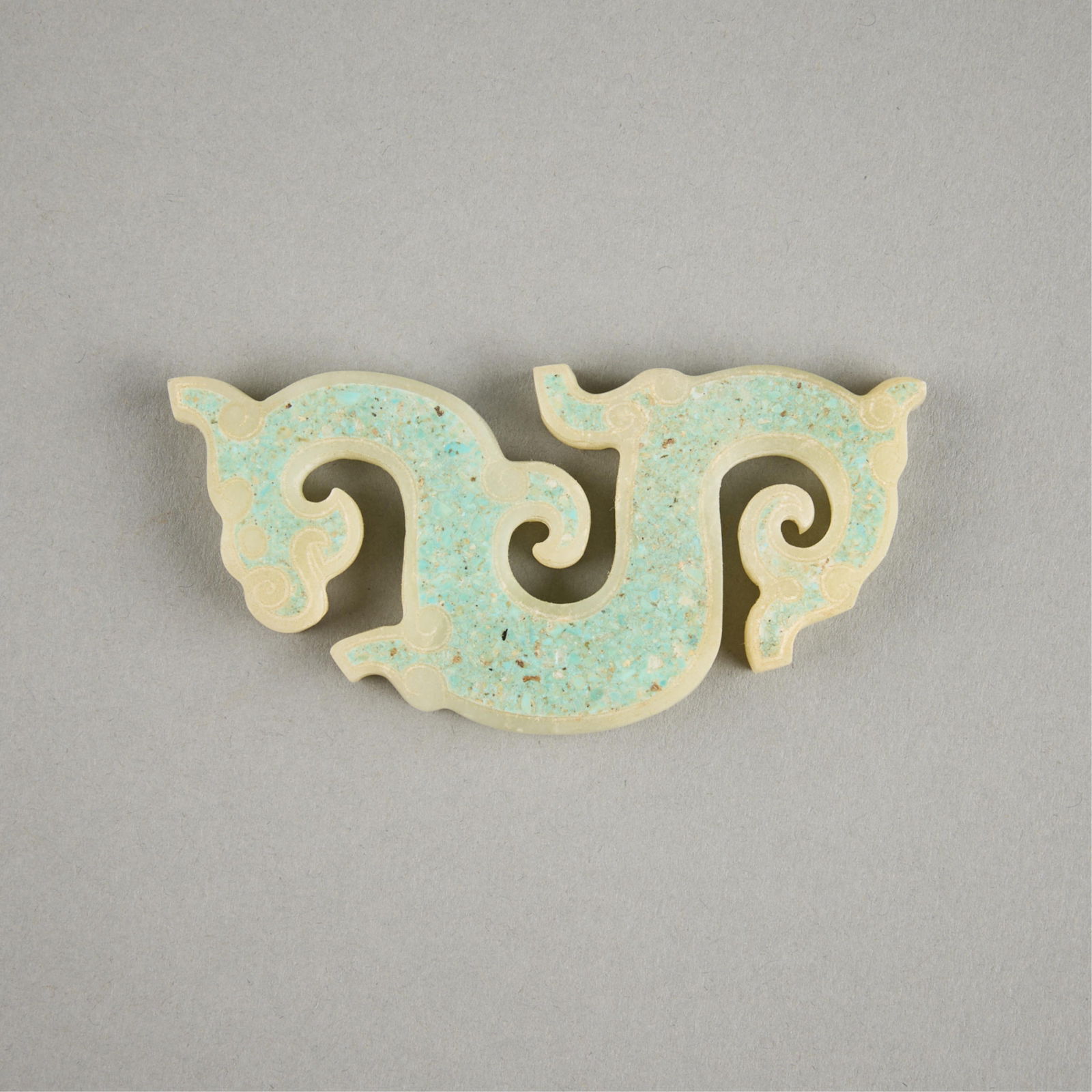Carved Jade Dragon with Turquoise Inlay: Carved jade in the form of a dynamic dragon. With inlaid turquoise colored stone.Height: 3 1/4 in x width: 1 3/4 in x depth: 1/4 in.