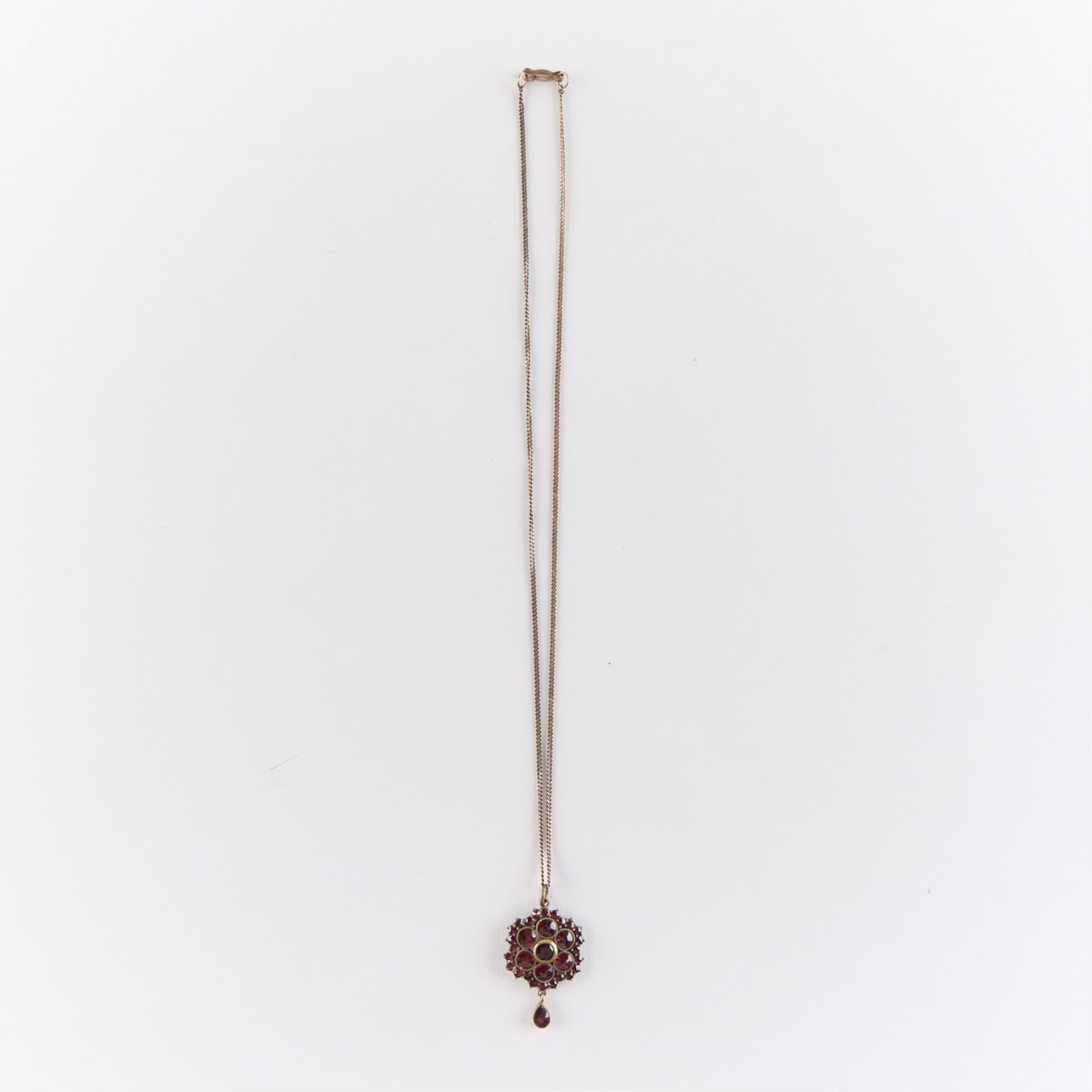 Victorian Bohemian Garnet Necklace: Victorian Bohemian garnet pendant on a cain with clasp marked sterling.Length: 18 in. Gross weight: 7.0 g.