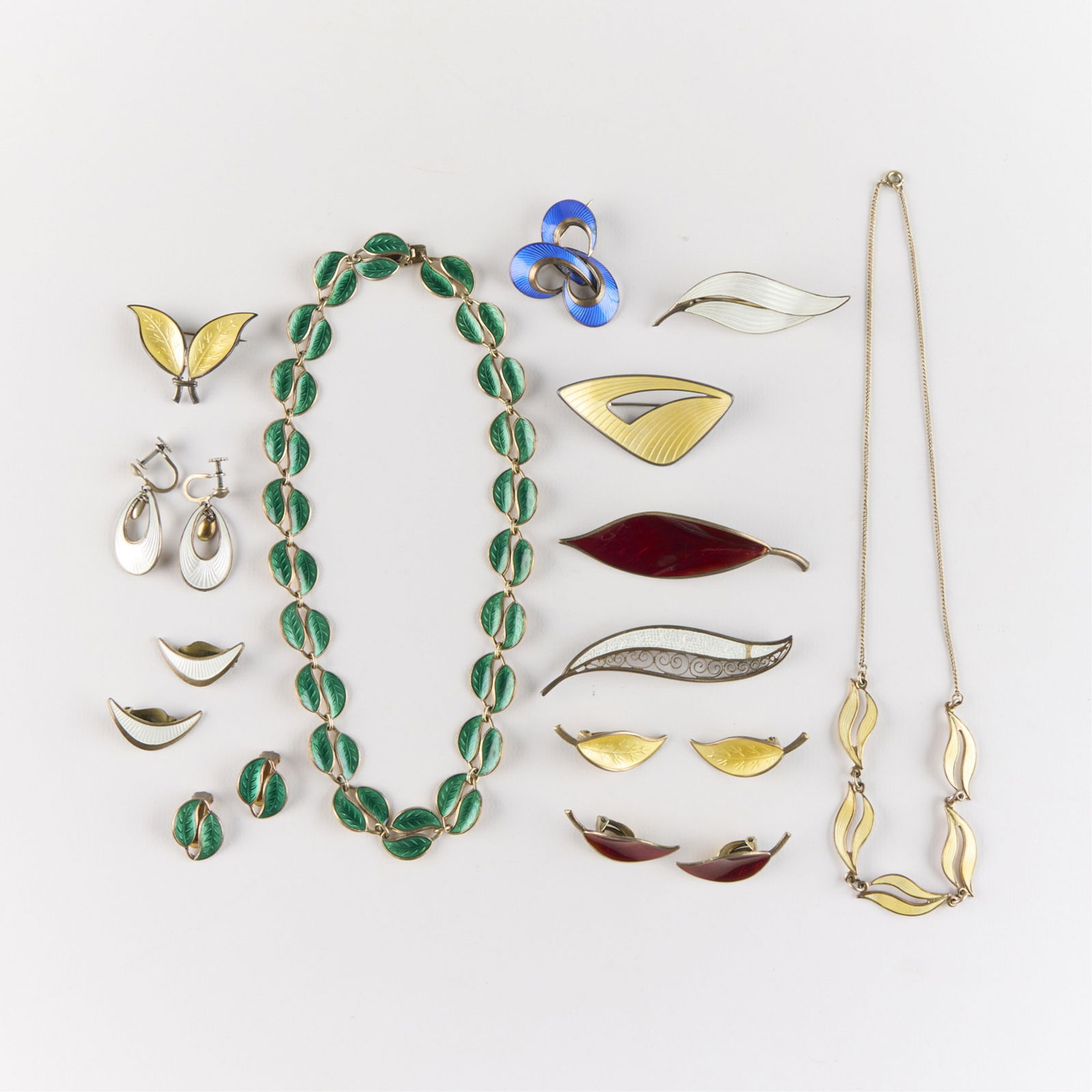 13 Pcs Sterling Silver Norwegian Enamel: Group of 13 sterling silver enameled Norwegian jewelry pieces. Including four pairs sterling clip-on earrings, one pair sterling dangle earrings, six sterling pin brooches, and two sterling