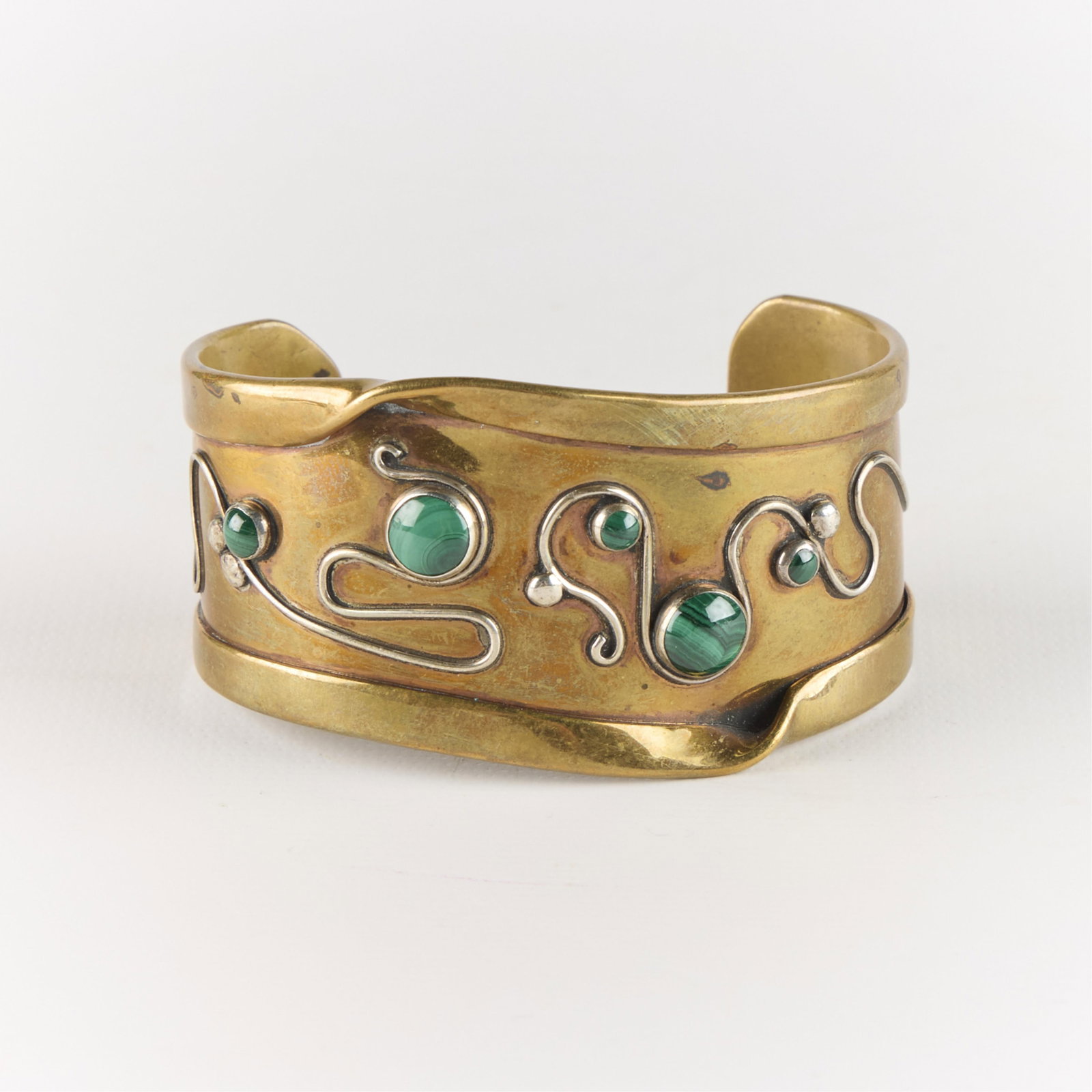 Modernist Mixed Metal & Malachite Cuff Bracelet: Modernist studio cuff bracelet composed of brass with intricate silver filigree and inset malachite stones. Unmarked.Diameter: 2 1/2 in. Gross weight: 46.41 g.