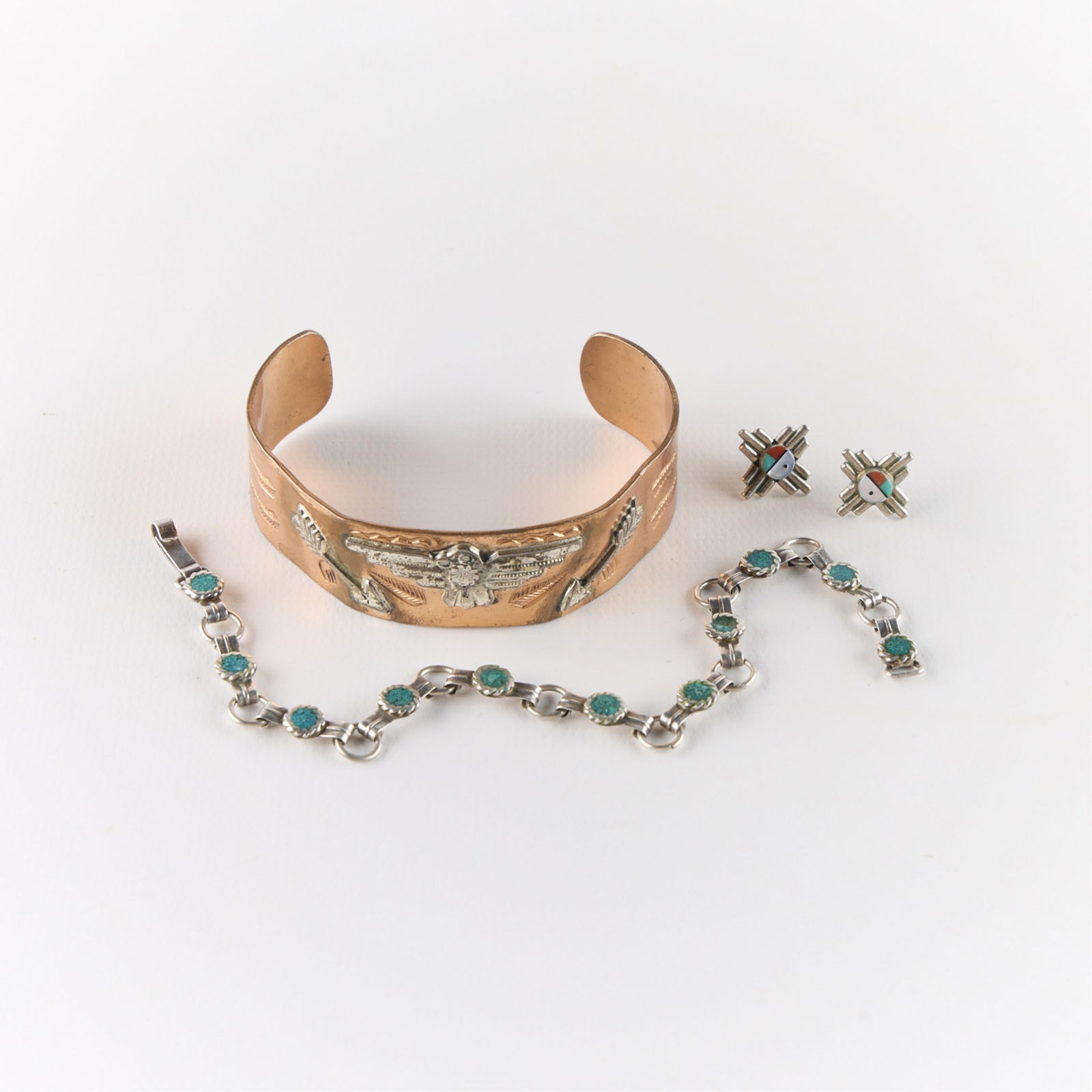 3 Pcs Native American Southwestern Style Jewelry: Group of Native American Southwestern-style sterling silver jewelry. Including one pair of Zuni sun face earrings, one copper cuff bangle bracelet with repousse sterling depictions of the thunderbird
