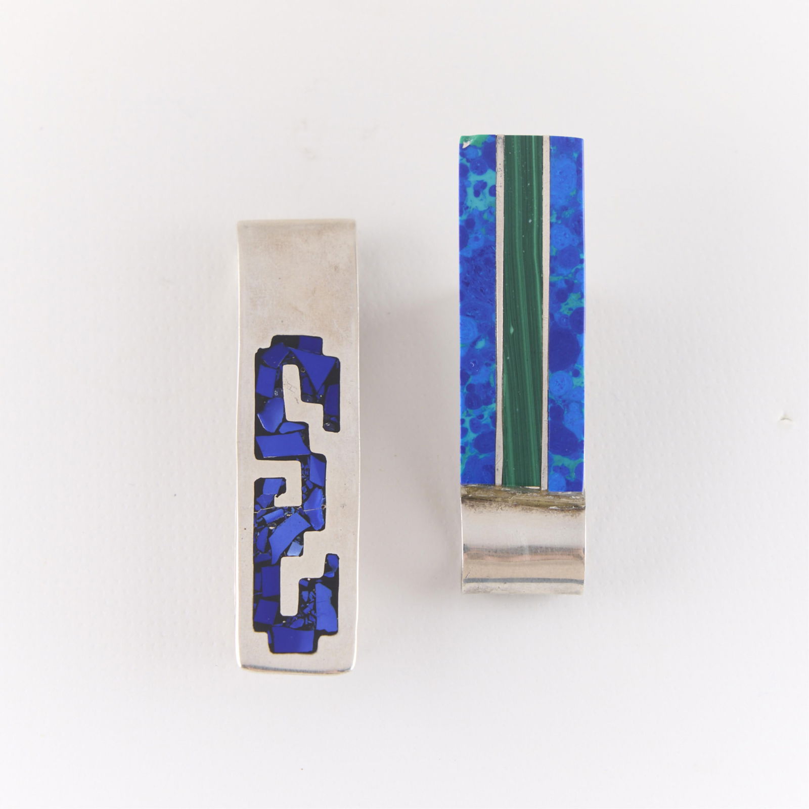 2 Mexican Sterling Silver Money Clips: Group of two Mexican sterling silver money clips. With inlaid gemstones. Each marked. (Each) Length: 2 1/4 in. Gross weight: 35.84 g.