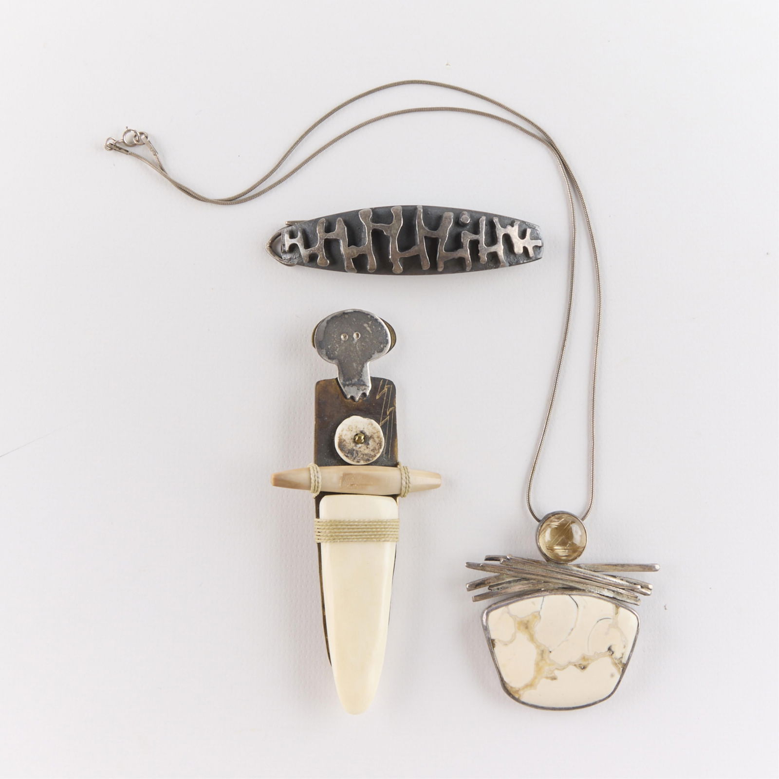 3 Pcs Modernist Jewelry Incl. Sterling: Including one sterling Christian Schmidt abstract brooch pin, one sterling necklace with inlaid stone pendant, and one illegibly signed modernist brooch pin. (Shipping dimensions) Height: 1/2 in x