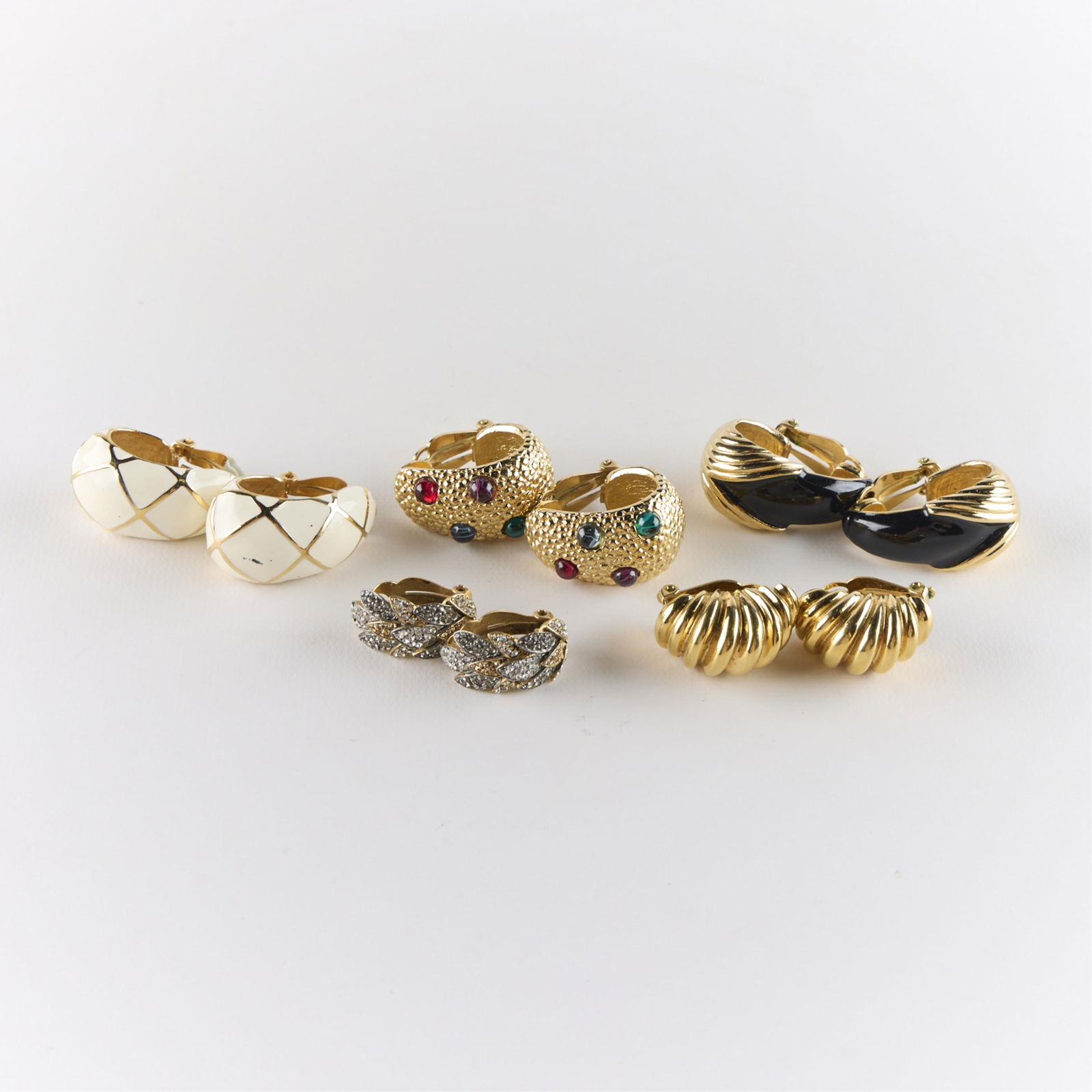 5 Pairs Gold-Toned Costume Earrings: Including three pairs of St. John earrings, one pair of Ciner earrings, and one pair of Oscar De La Renta earrings. Each marked. Gross weight: 143.99 g.