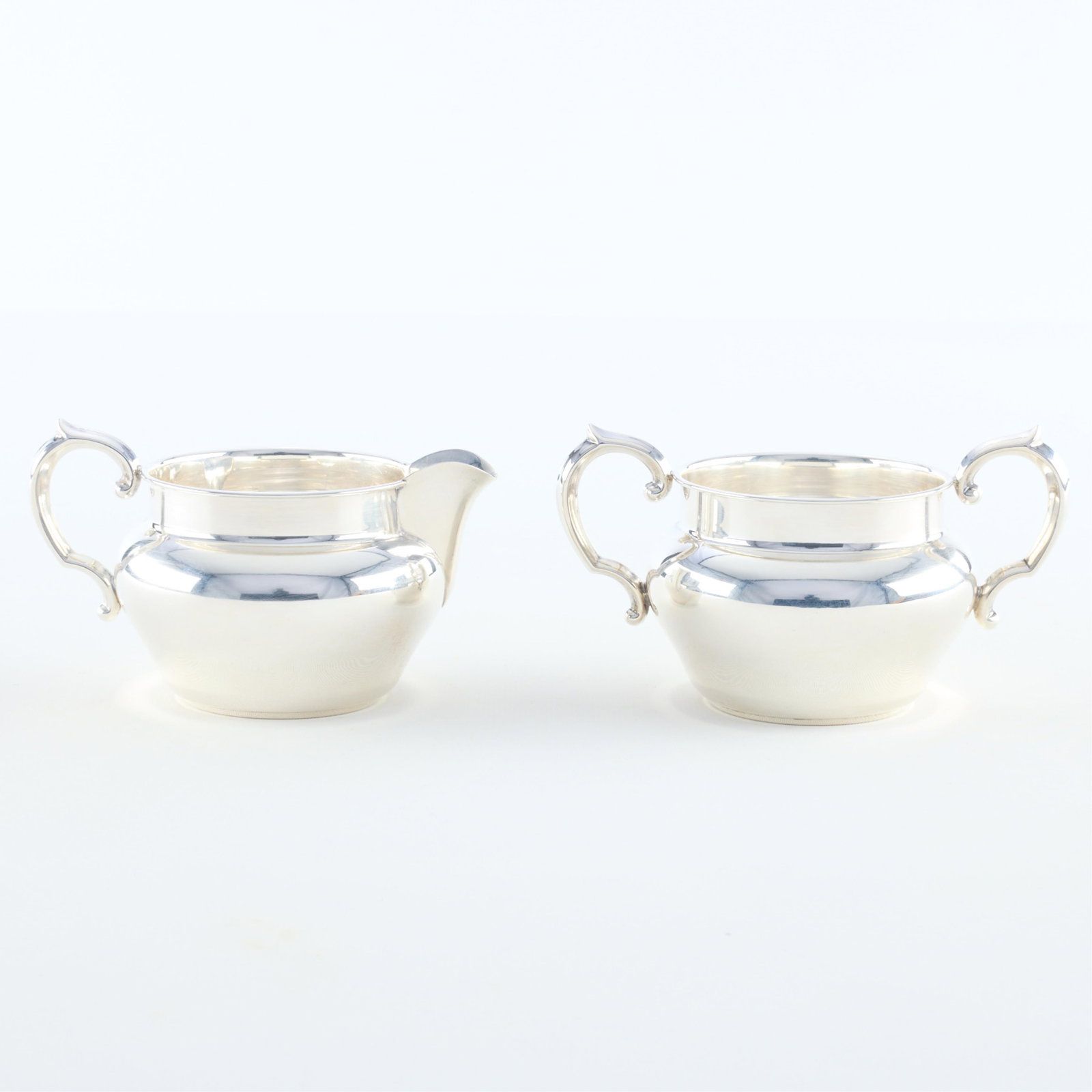 Reed & Barton Sterling Creamer & Sugar 5.79 ozt: Reed & Barton sterling silver hollowware creamer and sugar bowl, 20th century. Both marked and numbered 728 along the undersides. (Creamer) Height: 3 1/4 in x width: 5 in x diameter: 3 1/2 in. (Sugar