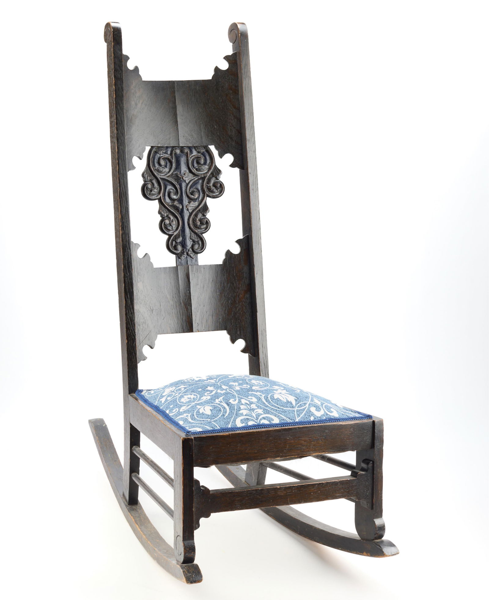 Antique American Oak Victorian Rocking Chair: Antique American Oak Victorian Rocking Chair. With blue and white upholstered seats.Height: 45 in x width: 18 in x depth: 37 in.