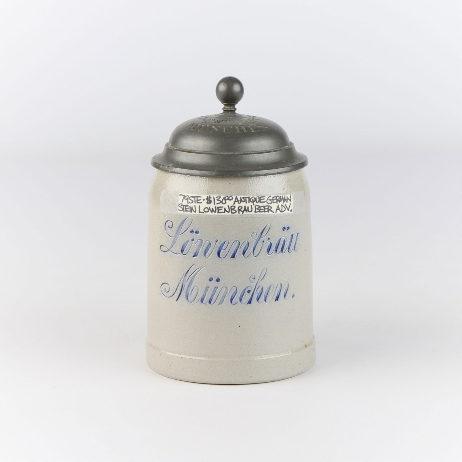 German Stoneware "Lowenbrau Brewery" Beer Stein: Antique German stoneware beer stein advertising Lowenbrau, one of Munich's oldest breweries. Stamped "A. Schneider Munchen" along the interior of lid.Height: 6 1/2 in x width: 5 1/4 in x diameter: 3 3