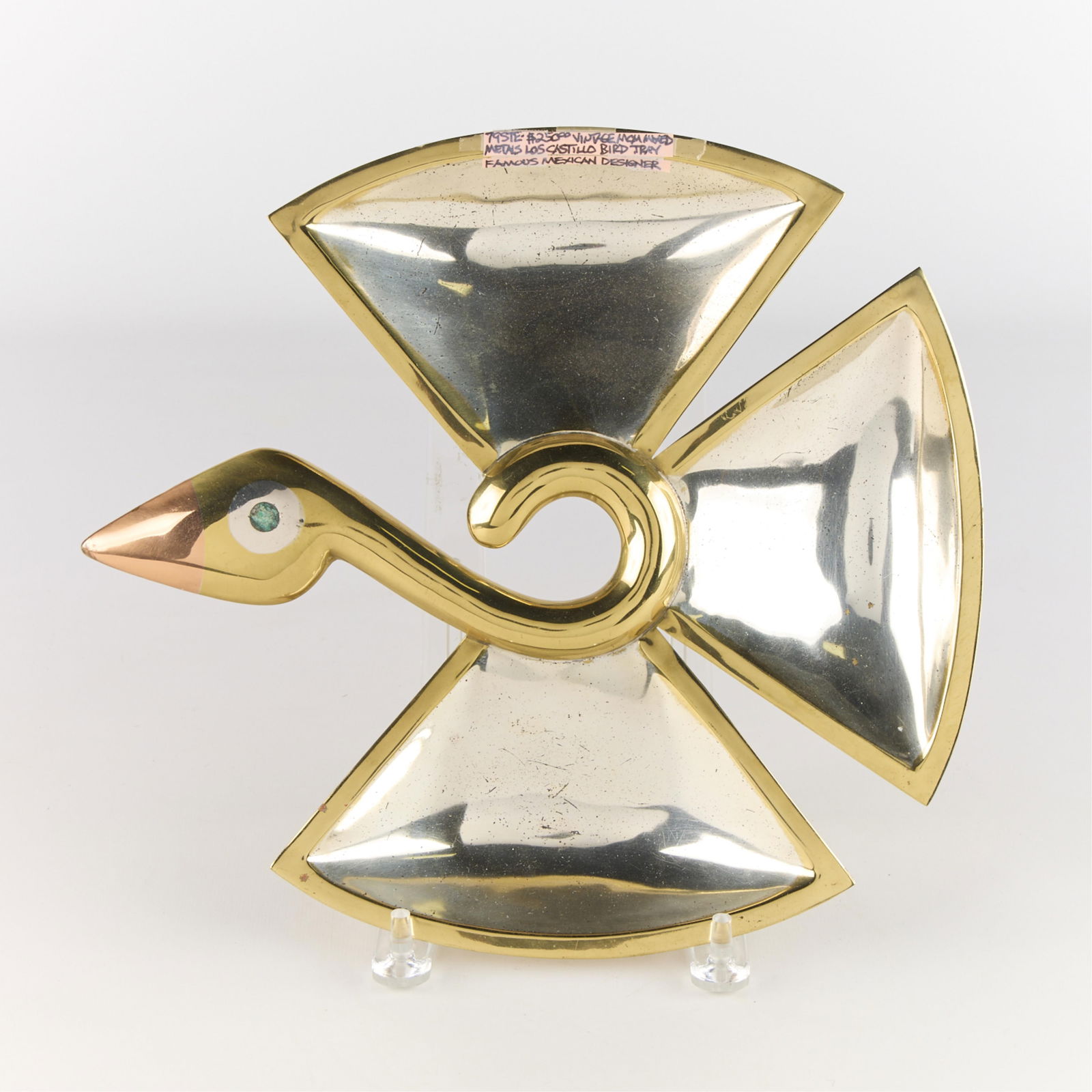 Los Castillo Mexico MCM Mixed Metal Bird Tray: Los Castillo, Taxco, Mexico. Mid-century modern mixed metal tray or dish in the form of a stylized bird, ca. 20th century. Marked along the underside. Height: 10 1/2 in x width: 12 in x depth: 1/2 in.