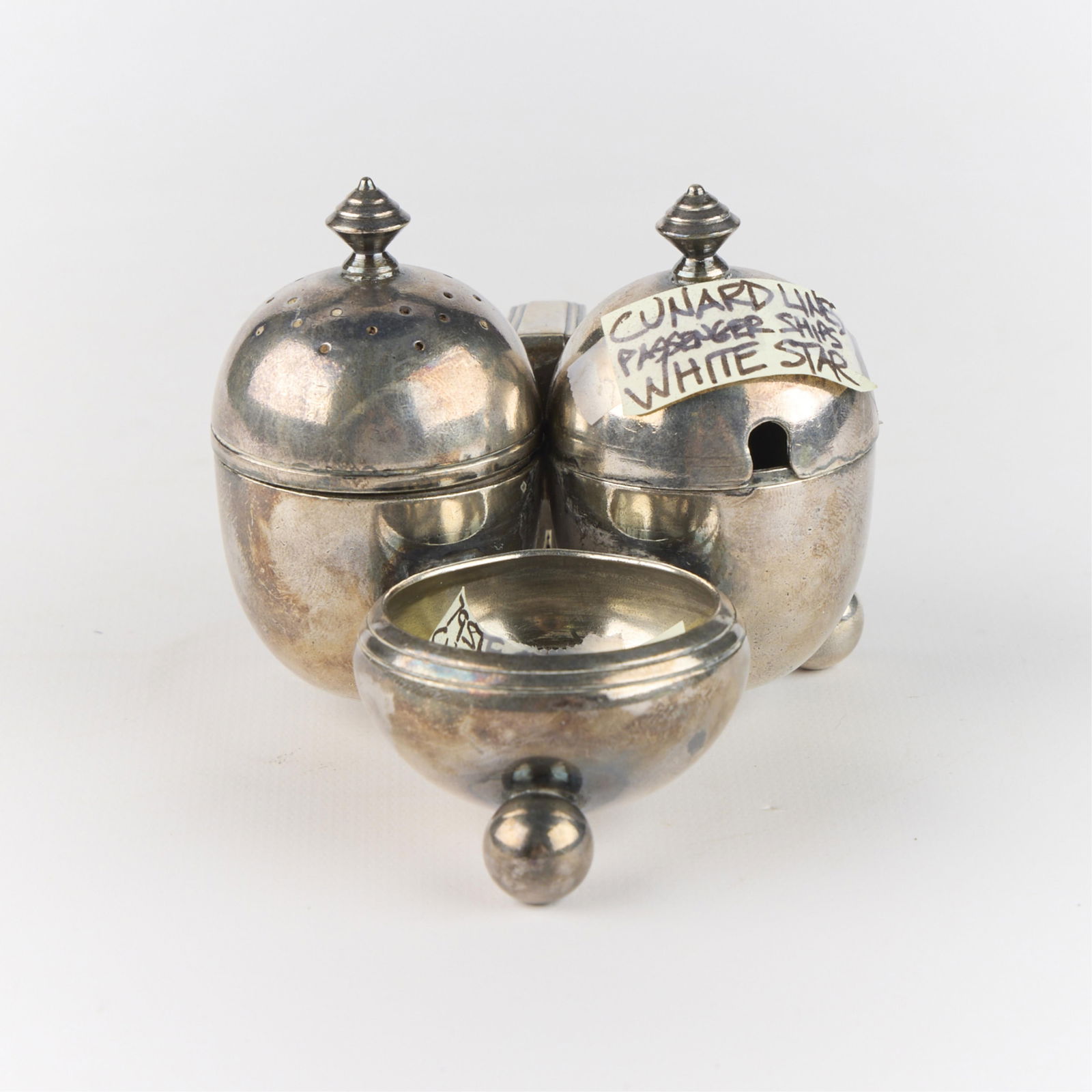Cunard White Star Lines Cruet Condiment S&P Set: Great Depression-era luxury ocean liner Cunard-White Star Line silverplate salt and pepper condiment set. Marked along the underside.Height: 3 in x width: 3 1/4 in x depth: 4/12.