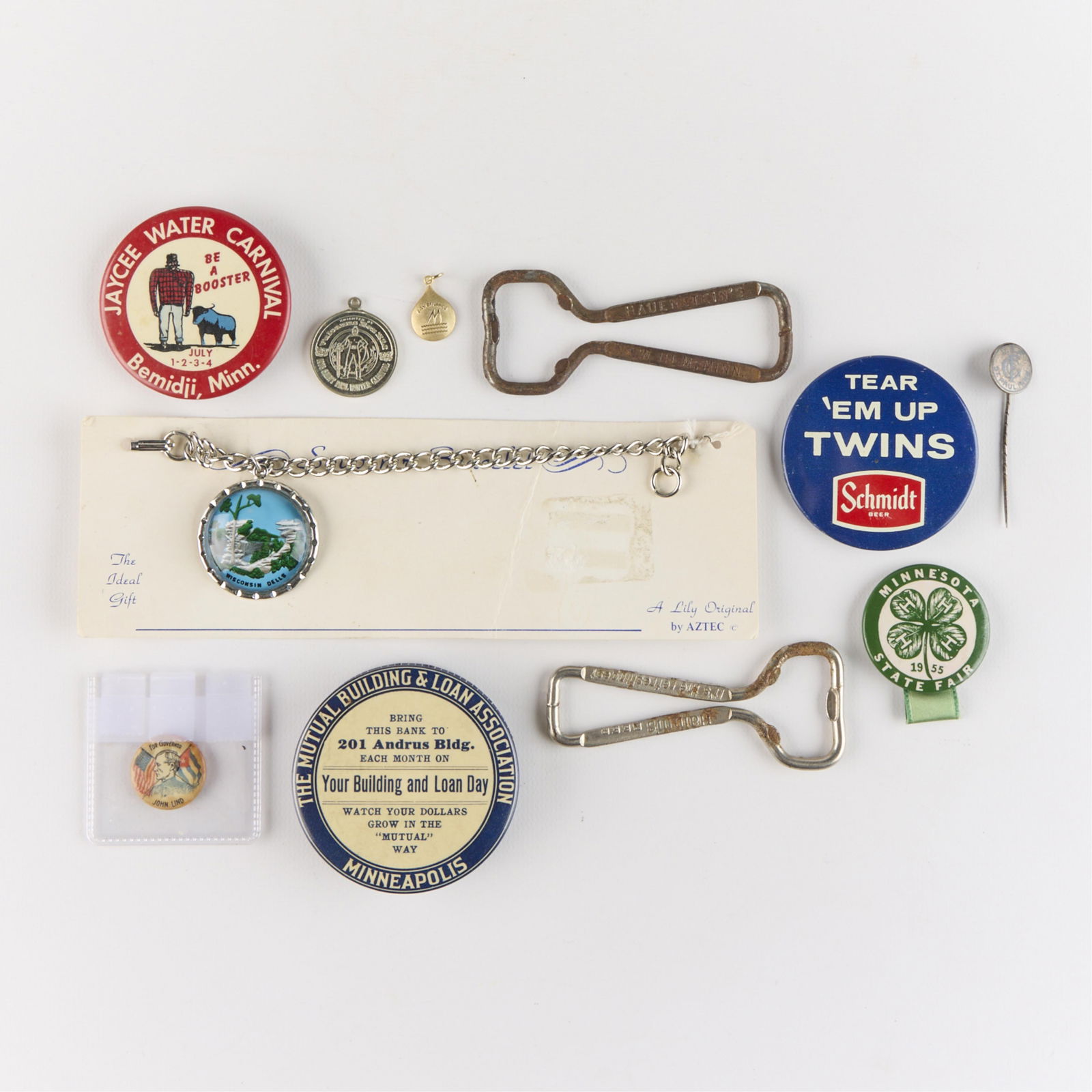 9 Vintage Minnesota & Wisconsin Pins & Badges: Group of nine vintage commemorative pins and badges related to Minnesota and Wisconsin. Including 1898 Minnesota "John Lind for Governor" campaign pin, glass and chrome Wisconsin Dells costume jewelry