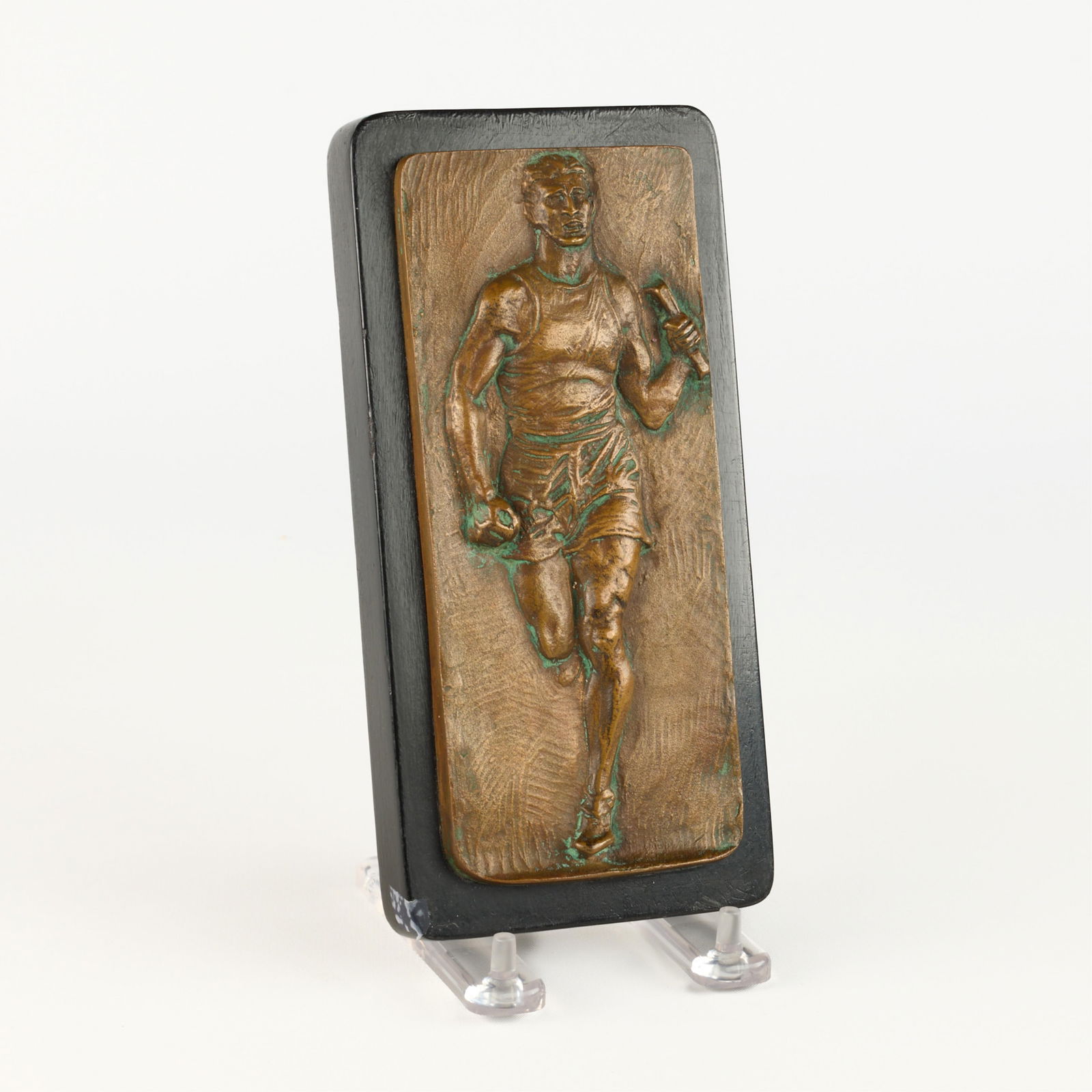 Art Deco Era Metal Relay Runner Athlete Plaque: Art Deco-era metal, likely brass or copper, plaque depicting a dynamic running athlete participating in a relay race. Mounted atop a wooden backing. Height: 7 1/2 in x width: 3 1/2 in x depth: 1 1/4