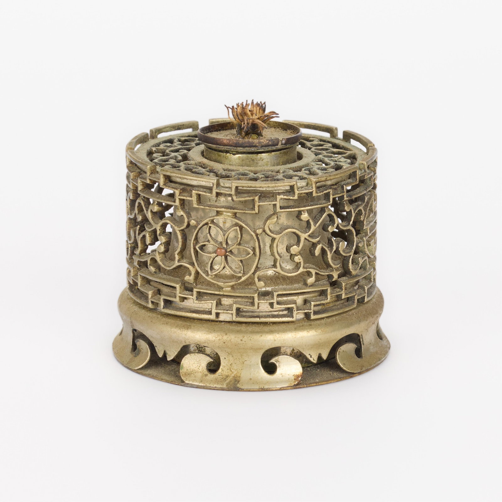 Small Tibetan Pierced Metal Lamp: Small pierced metal lamp, possibly bronze. Likely from Tibet. Height: 2 3/4 in x diameter: 3 in.