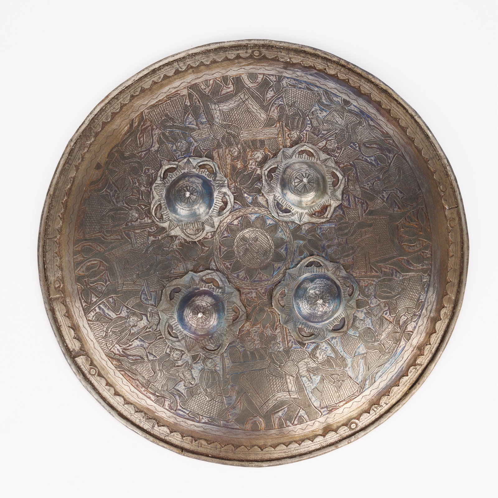 Reproduction Persian Shield: Reproduction Persian metal shield. Incised design of figures walking with camels. Diameter: 17 1/4 in.