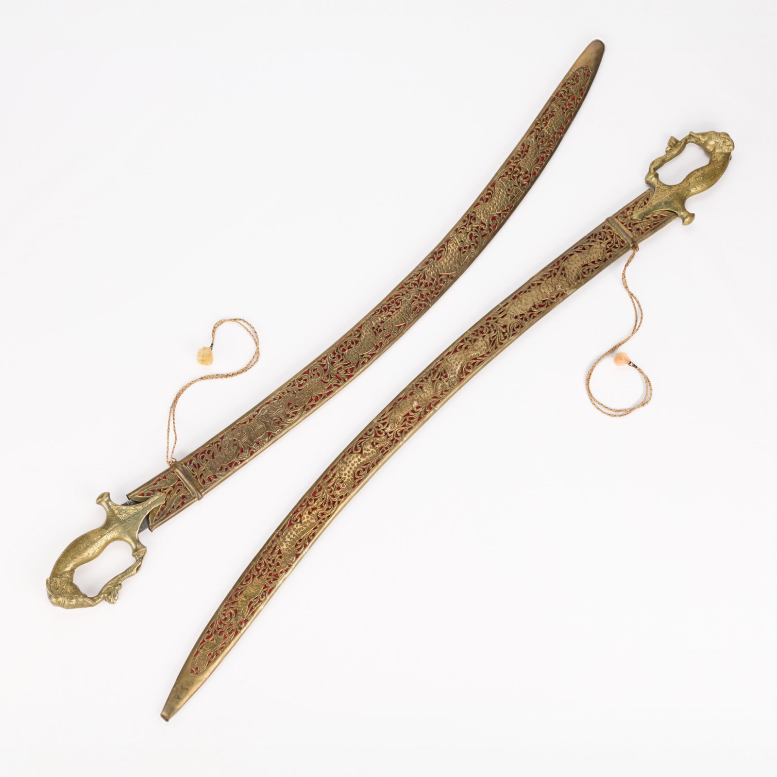 Pr Reproduction Indian Wedding Swords: Pair of reproduction Indian wedding swords, often referred to as a Talwar or Shamshir. Hilts in the form of elephants. (Each) Blade length: 32 in. Overall length: 37 1/2 in.