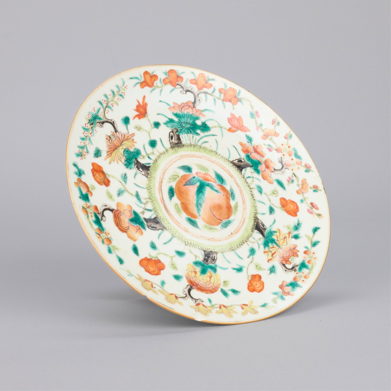 Chinese Porcelain Footed Platter Tazza: Chinese porcelain raised platter or tazza, ca. 20th/21st century. Executed in coral, green, and yellow glazes on white ground. Depicting a central peach motif, lotus flowers along the rim, and bats al