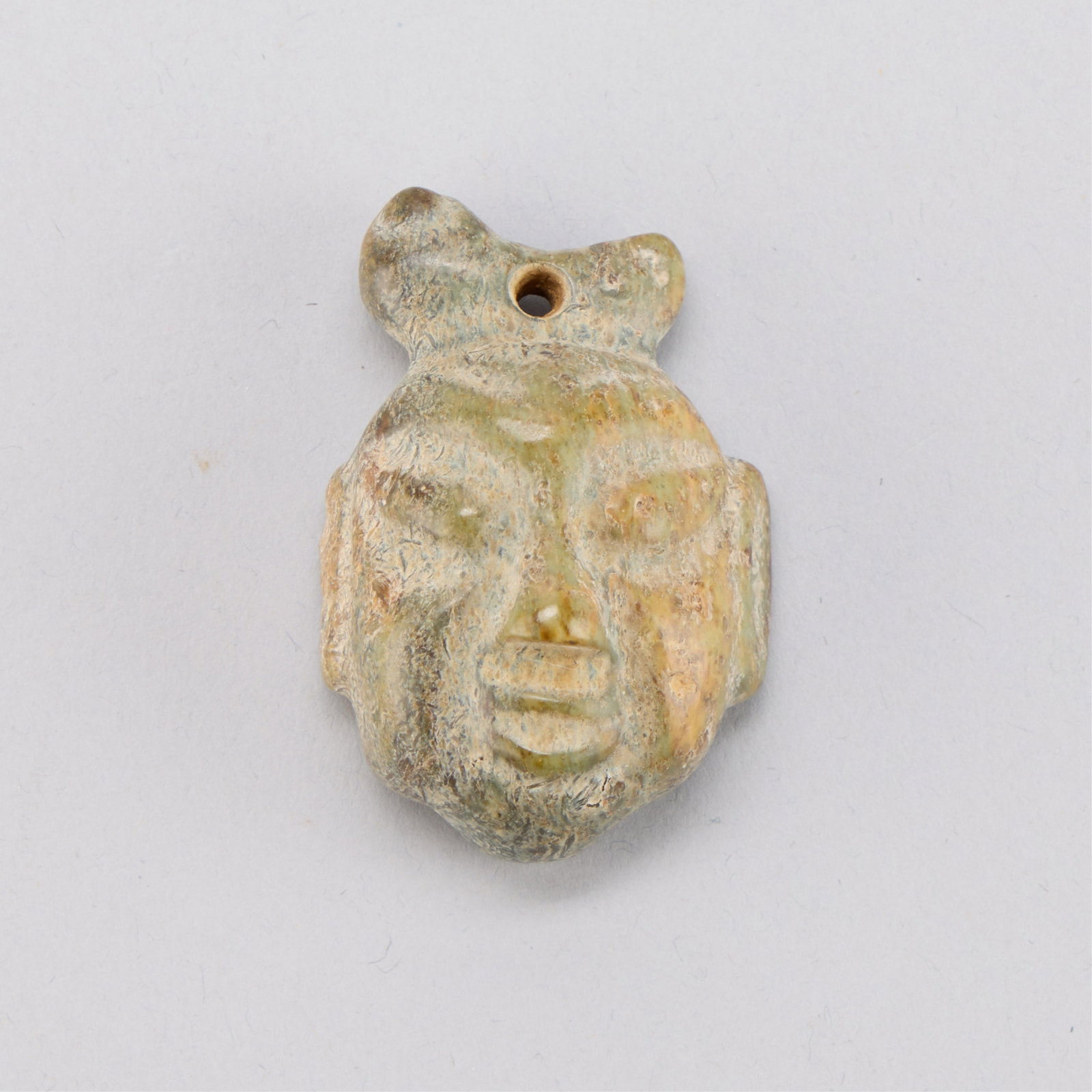 Chinese Hongshan Style Jade Head: Chinese Hongshan Culture style jade carvingin the form of a head. Height: 2 1/8 in x width: 1 3/8 in x depth: 1 in. Weight: 50.24 g.