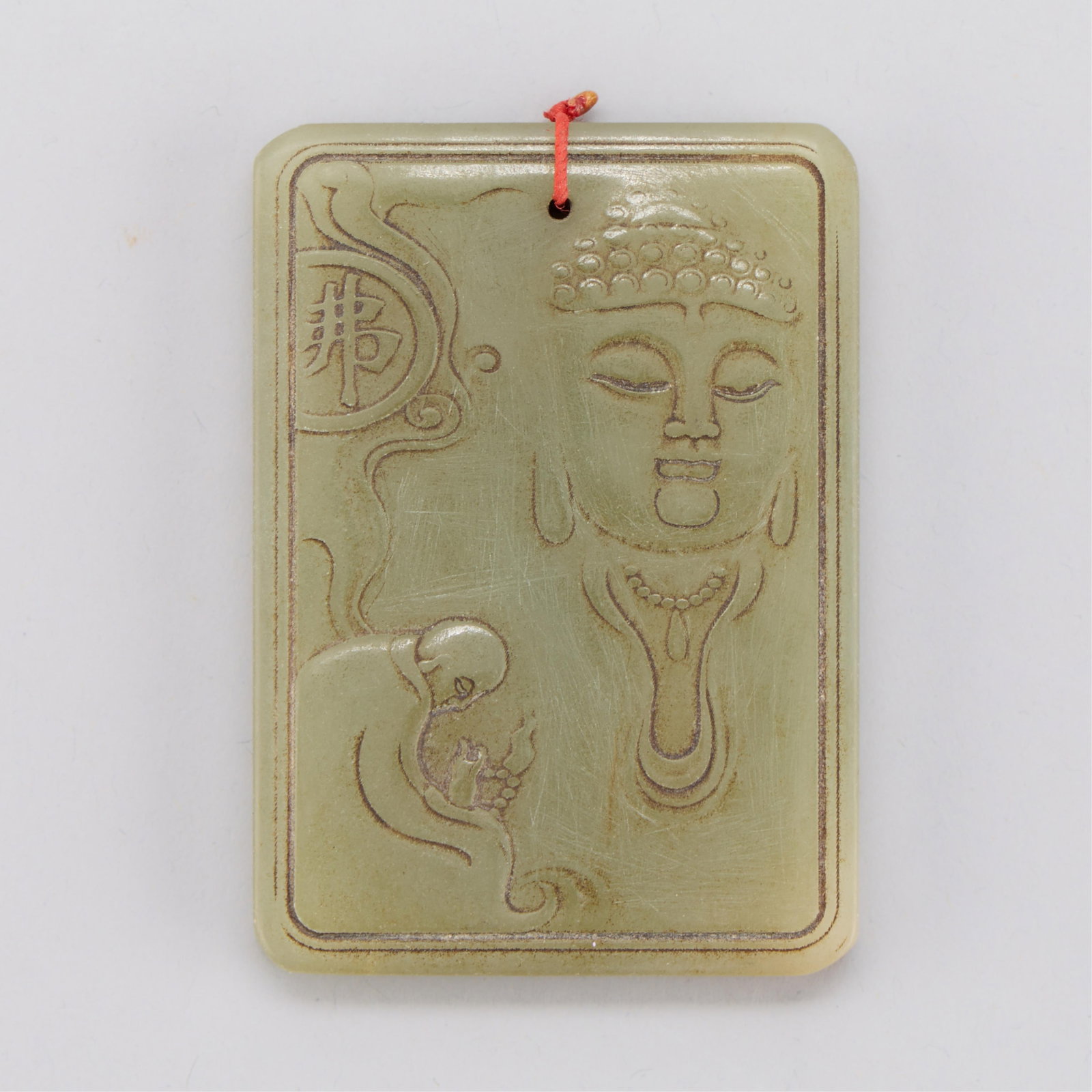 Chinese Hetian Jade Buddha Plaque: Chinese Hetian jade plaque carved along one side with a figure bowed in reverance to a large figure of a buddha; the other side with incised characters surrounded by a Greek key border. Height: 2 3/4 