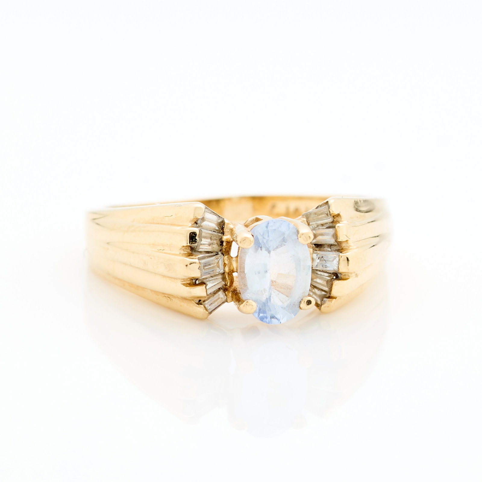 14k Yellow Gold Ring Sz 8: 14k yellow gold ring set with oval aquamarine and accented with a spray of baguette-cut diamonds. Marked 14k CJC. Ring size: 8 US. Gross weight: 4.43 g