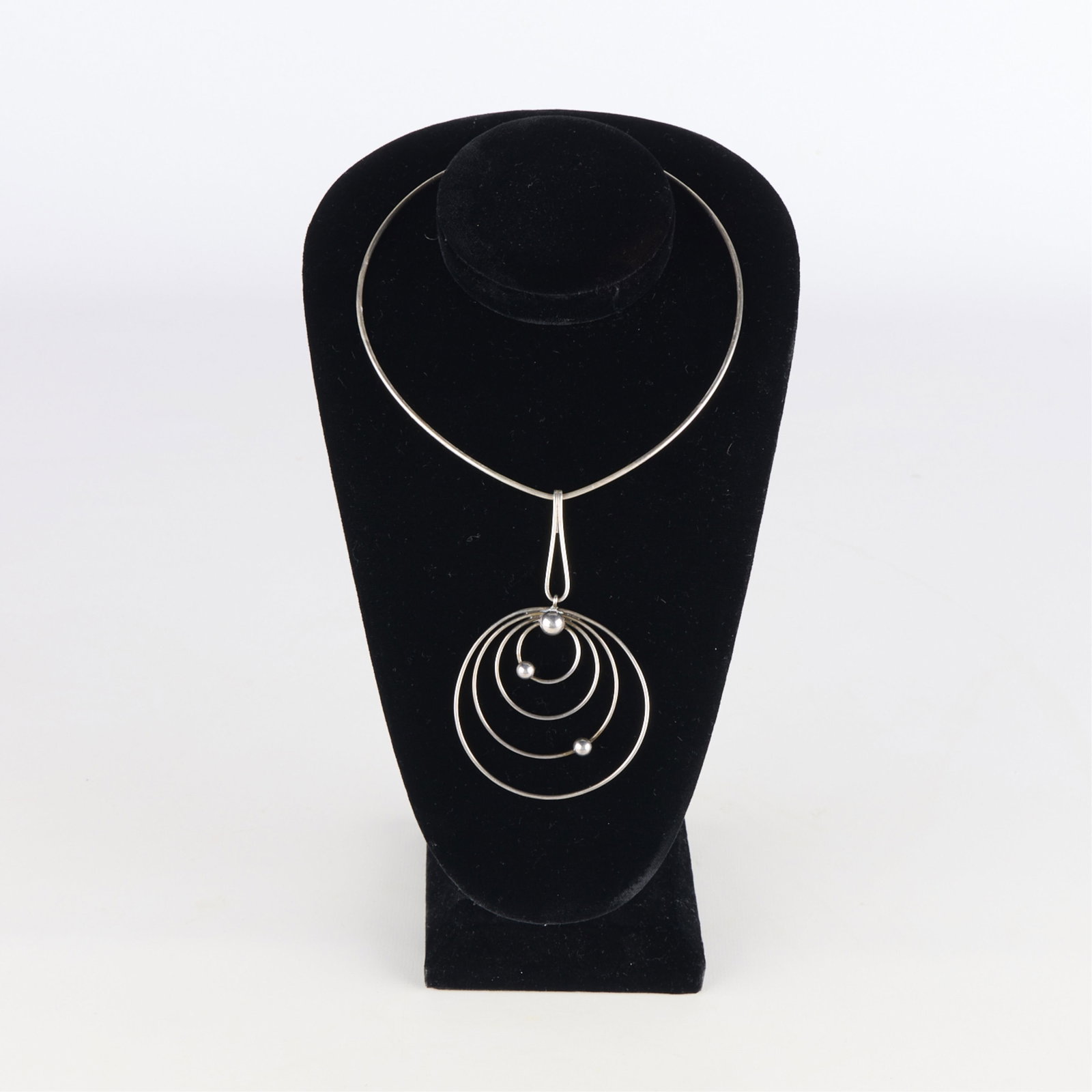 Sterling Modernist Necklace: Sterling modernist style necklace. Marked "sterling" along the pendant, marked "925" along the band of necklace. Weight: 25.50485 g