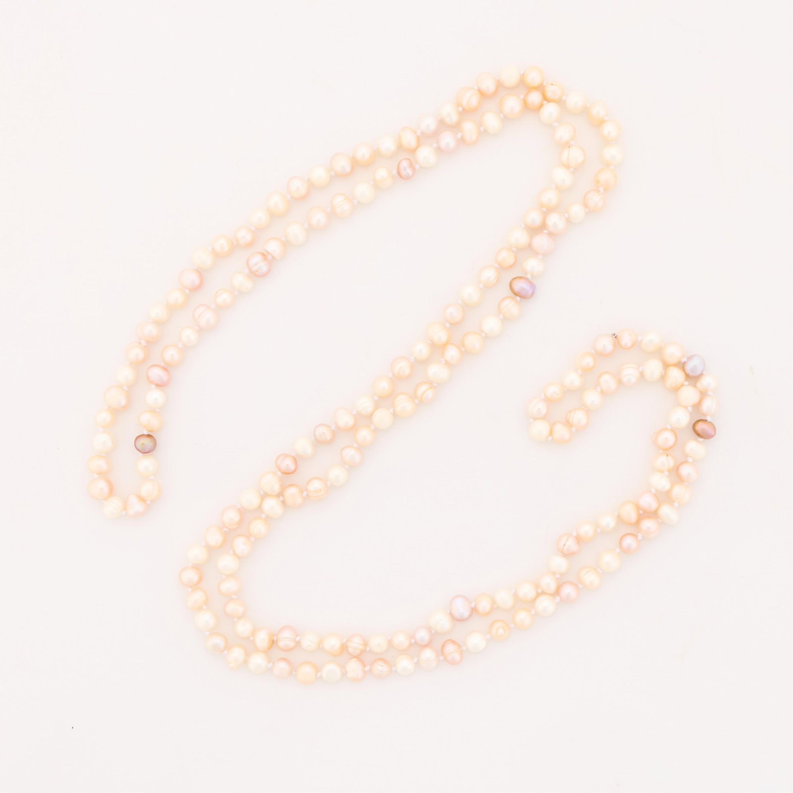 Opera Length Baroque Pearl Strand: Opera length strand with baroque pearls in pink and rose tones. Length: 56 in. Gross weight: 92.1 g.