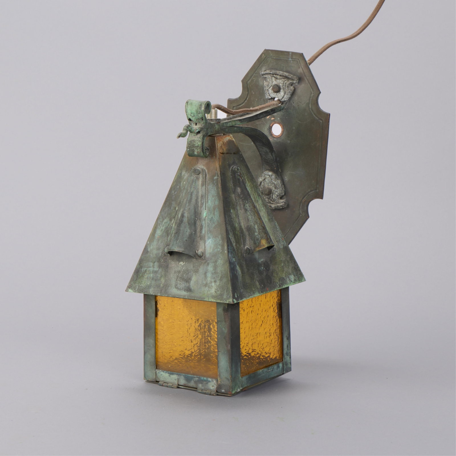 Arts & Crafts Mission Style Wall Sconce Lantern: Arts & Crafts Mission style wall sconce lantern light. With amber stained glass panels and copper frame. With lovely verdigris patina. Height: 11 in x width: 5 in x depth: 8 in.