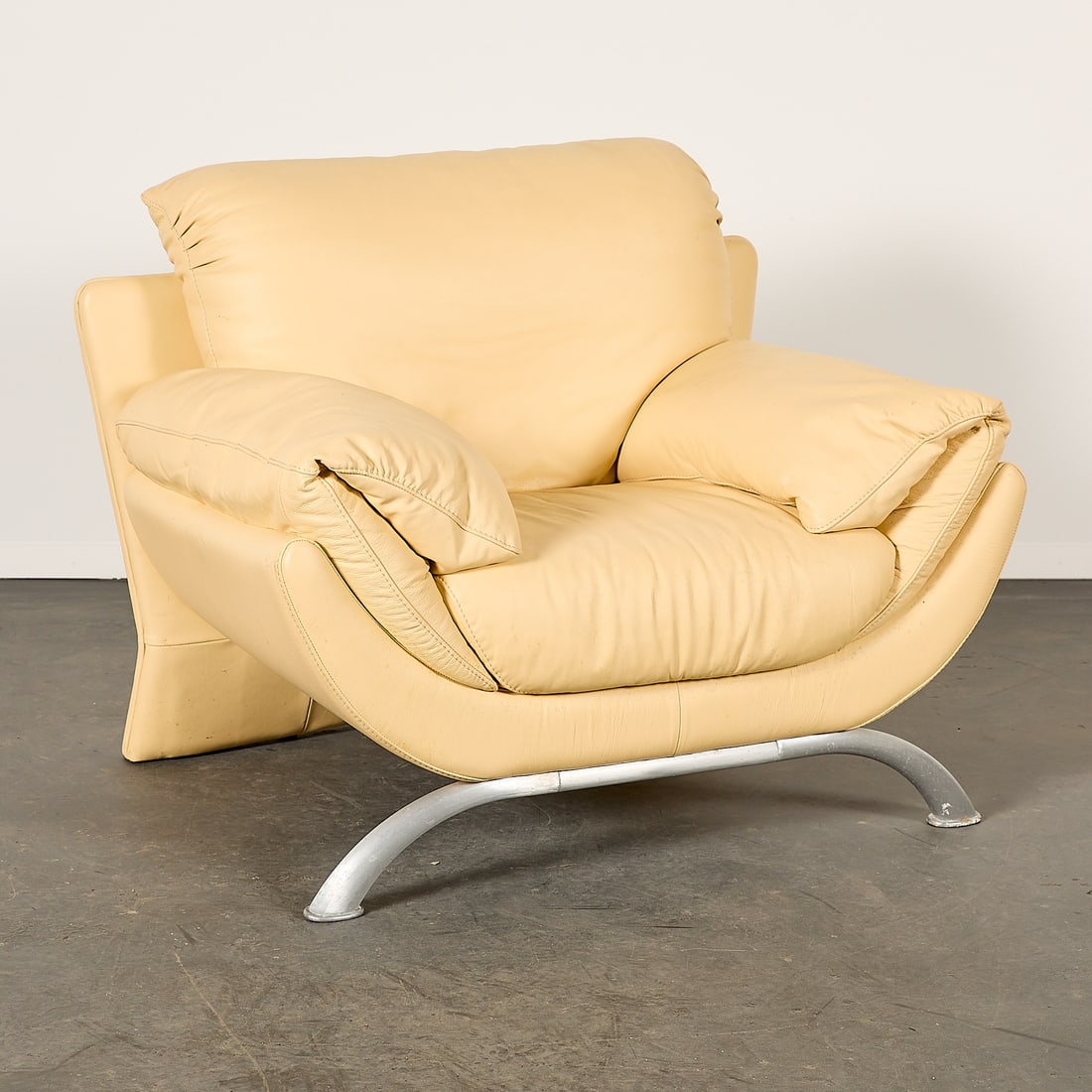 Vintage Post Modern Italian Faux Leather Arm Chair: Vintage post-modern Italian faux leather arm chair, ca. 1990s. Resting on curved chrome pipe legs. Height: 32 in x width: 39 in x depth: 30 in.