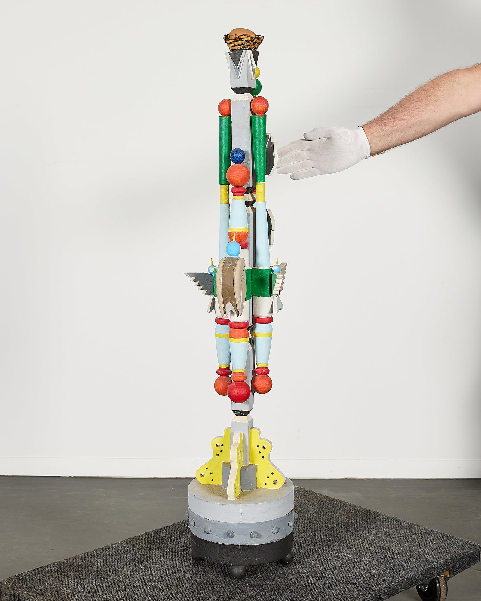 M. Lewis Croissant HandPainted Wood Totem Pole 47": M. Lewis Croissant (1900-1989). Handpainted and carved modernist totem pole. Painted in gray with vibrant yellow, red, gree, and blue. With motifs of birds surmouted by a bird's nest. Croissant was a 