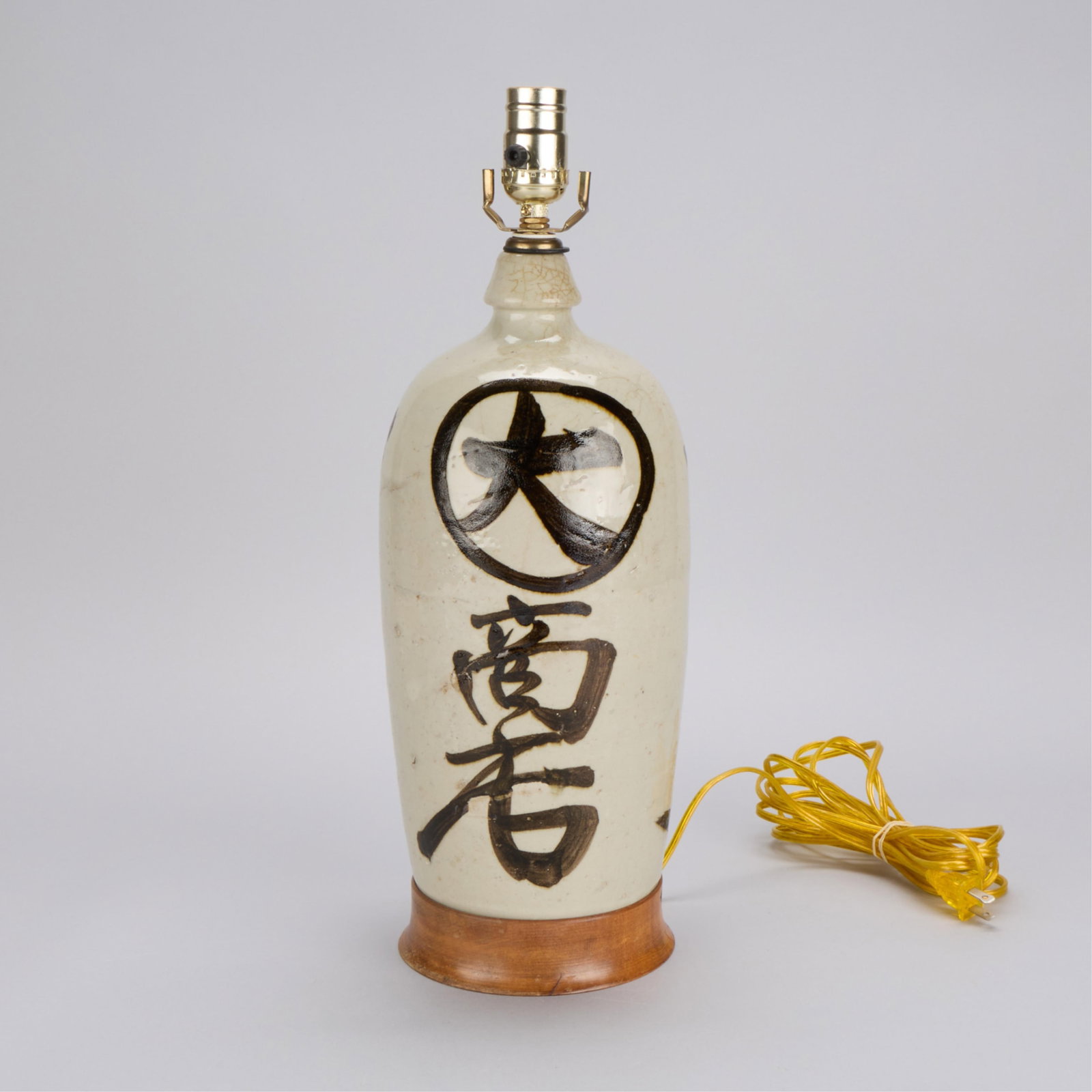Japanese Ceramic Sake Bottle Kayoi Tokkuri Lamp: Japanese ceramic table lamp base in the form of a large sake bottle, also known as a kayoi tokkuri. Height: 18 3/4 in x diameter: 6 1/4 in.