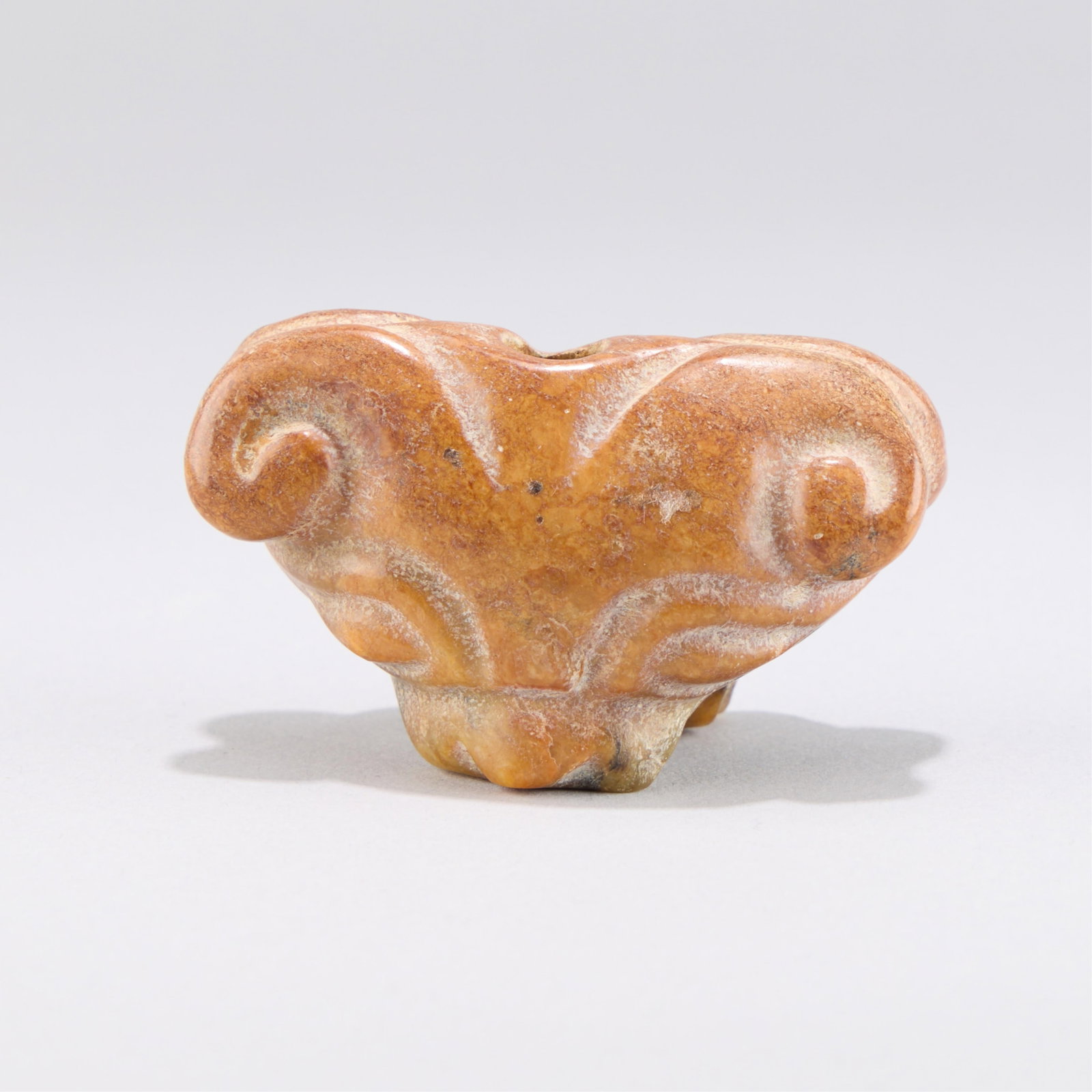 Chinese Jadeite Ram's Head Carving: Chinese jade or jadeite carved pendant in the form of a ram's head. Depicted with a wide, open mouth. Height: 1 5/8 in x width: 2 1/2 in x depth: 1 3/8 in. Weight: 92.88 g.