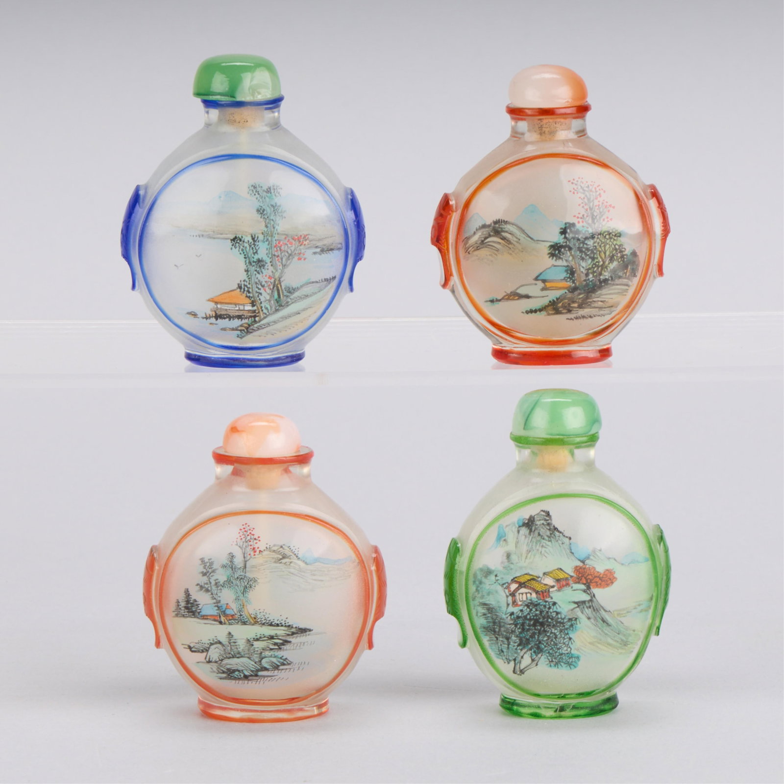 4 20th c. Chinese Glass Snuff Bottles: Group of four Chinese colorful inside-painted glass snuff bottles. Painted to depict landscapes. (Each, approx) height: 2 3/4 in x width: 2 in x depth: 1 in.