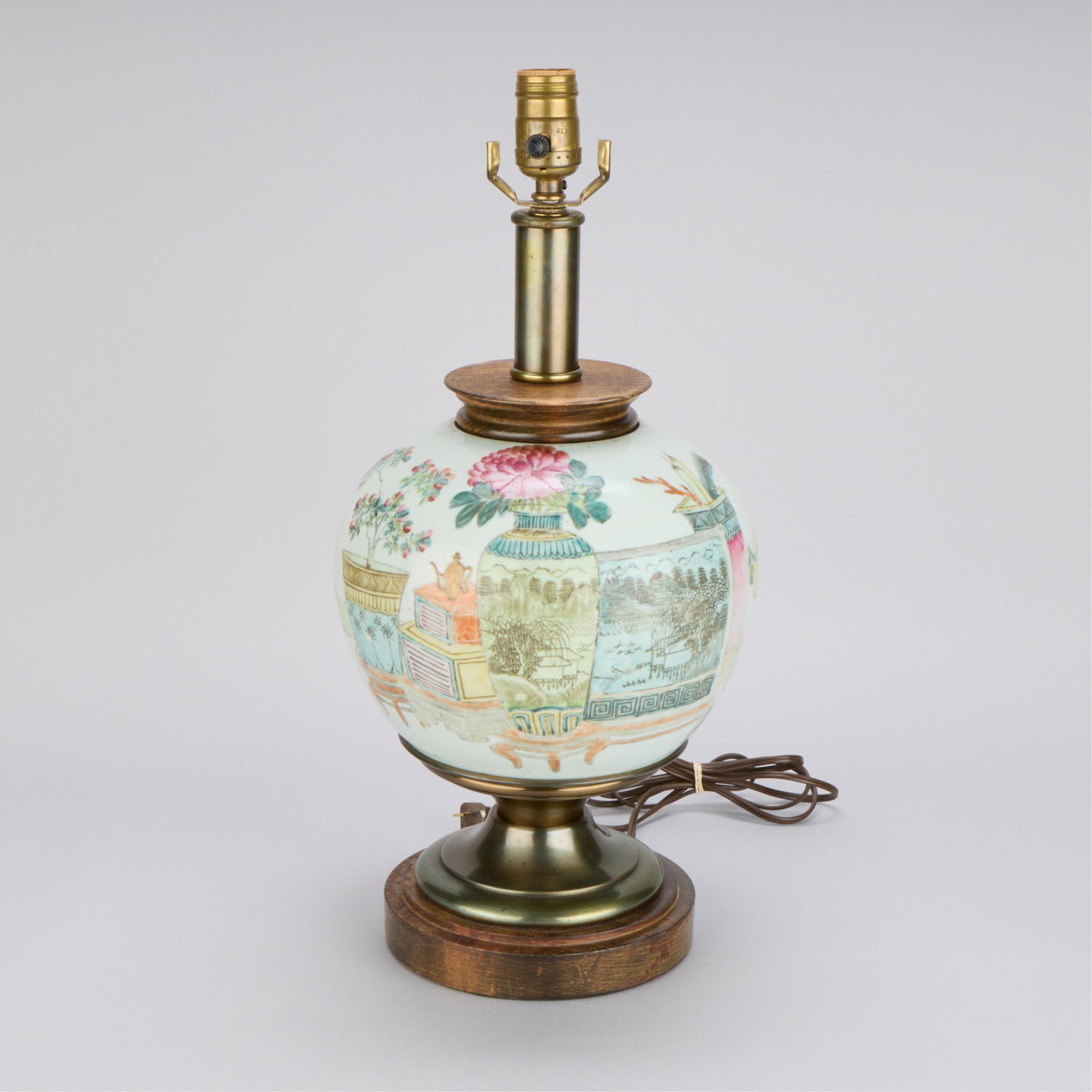 Chinese Porcelain Famille Rose Jar as Lamp: Chinese famille rose porcelain jar mounted as a table lamp of bulbous form with painted foliate motifs and calligraphy inscriptions. Height: 19 1/2 in x diameter: 9 1/2 in.