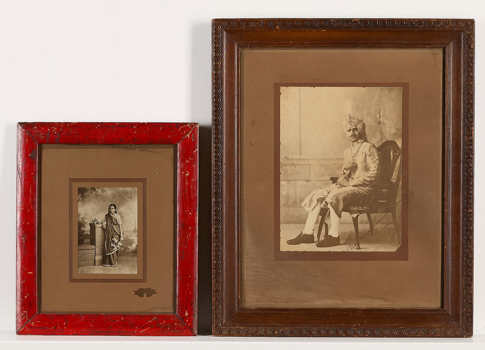 2 Antique Photographs of Indians: Group of two antique photograph portraits of a man and woman, likely from India. (Smaller) height: 14 1/2 in x width: 12 1/2 in x depth: 1 in. (Larger) height: 21 1/4 in x width: 17 1/2 in x depth: 1 