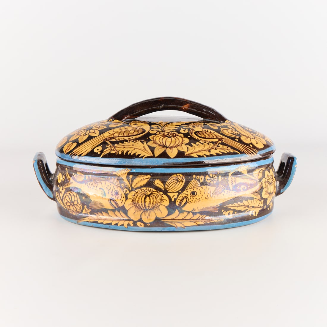 Mexican Tlaquepaque Pottery Casserole Dish: Mexican folk art Tlaquepaque tourist pottery ceramic casserole dish with two handles and a lid, ca. 1950s. With decoration of birds, fish, and flowers in yellow, blue, and black glaze. Height: 6 in x 