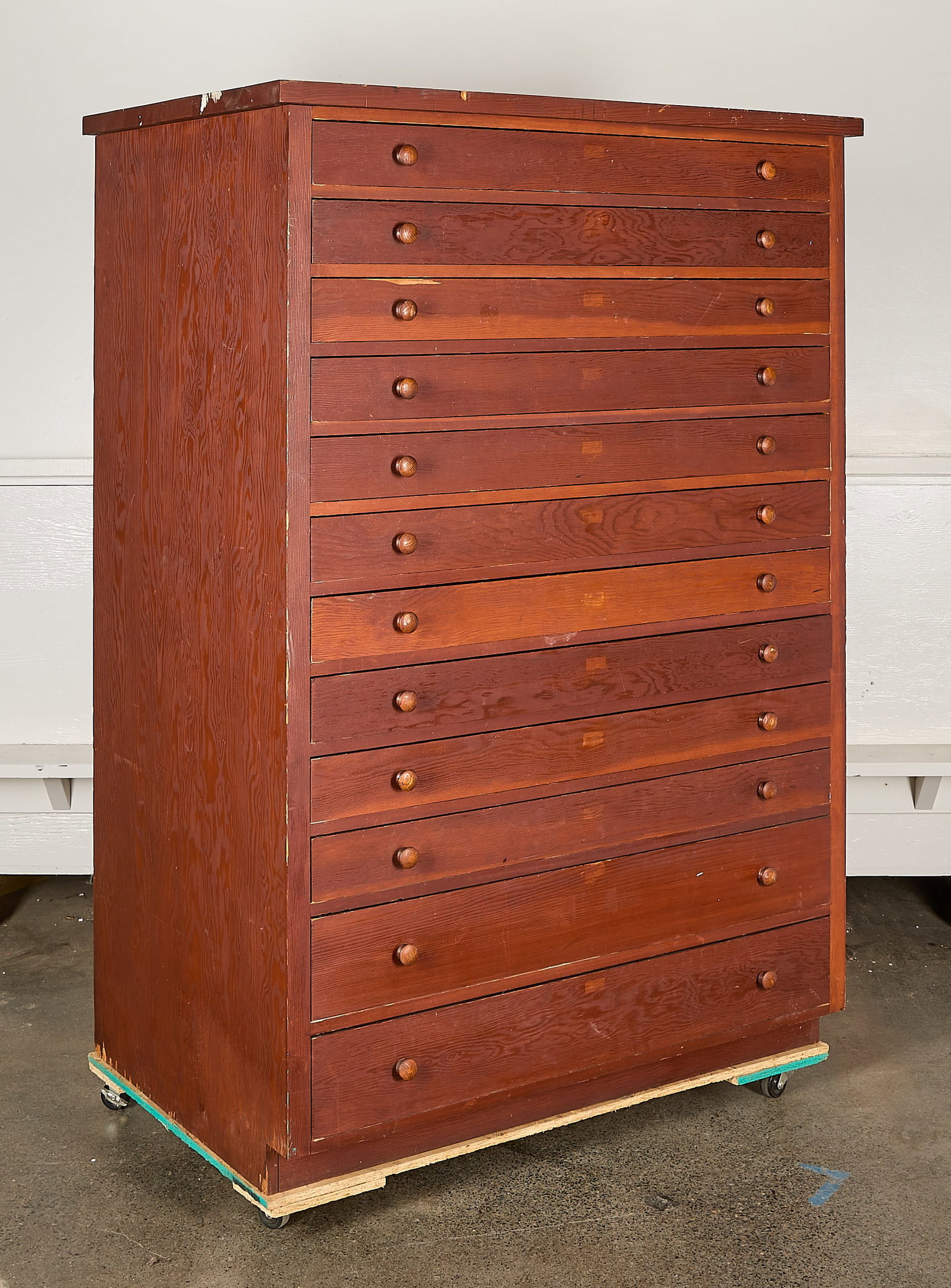 Antique Wooden 12-Drawer Filing Cabinet: Antique wooden filing or drawing cabinet with 12 drawers, each featuring rounded wooden door handles. Height: 67 in x width: 42 1/2 in x depth: 29 in.